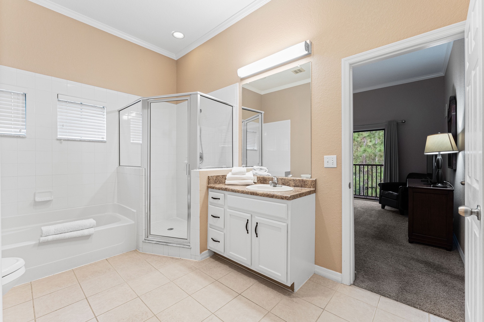 A single vanity, shower, & tub await in the Jack & Jill ensuite bath