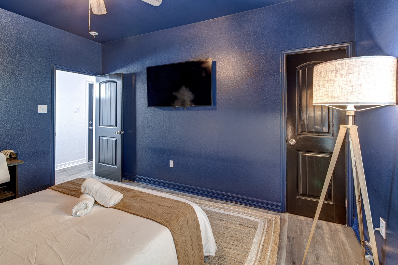 The second bedroom retreat features a plush queen bed & Smart TV