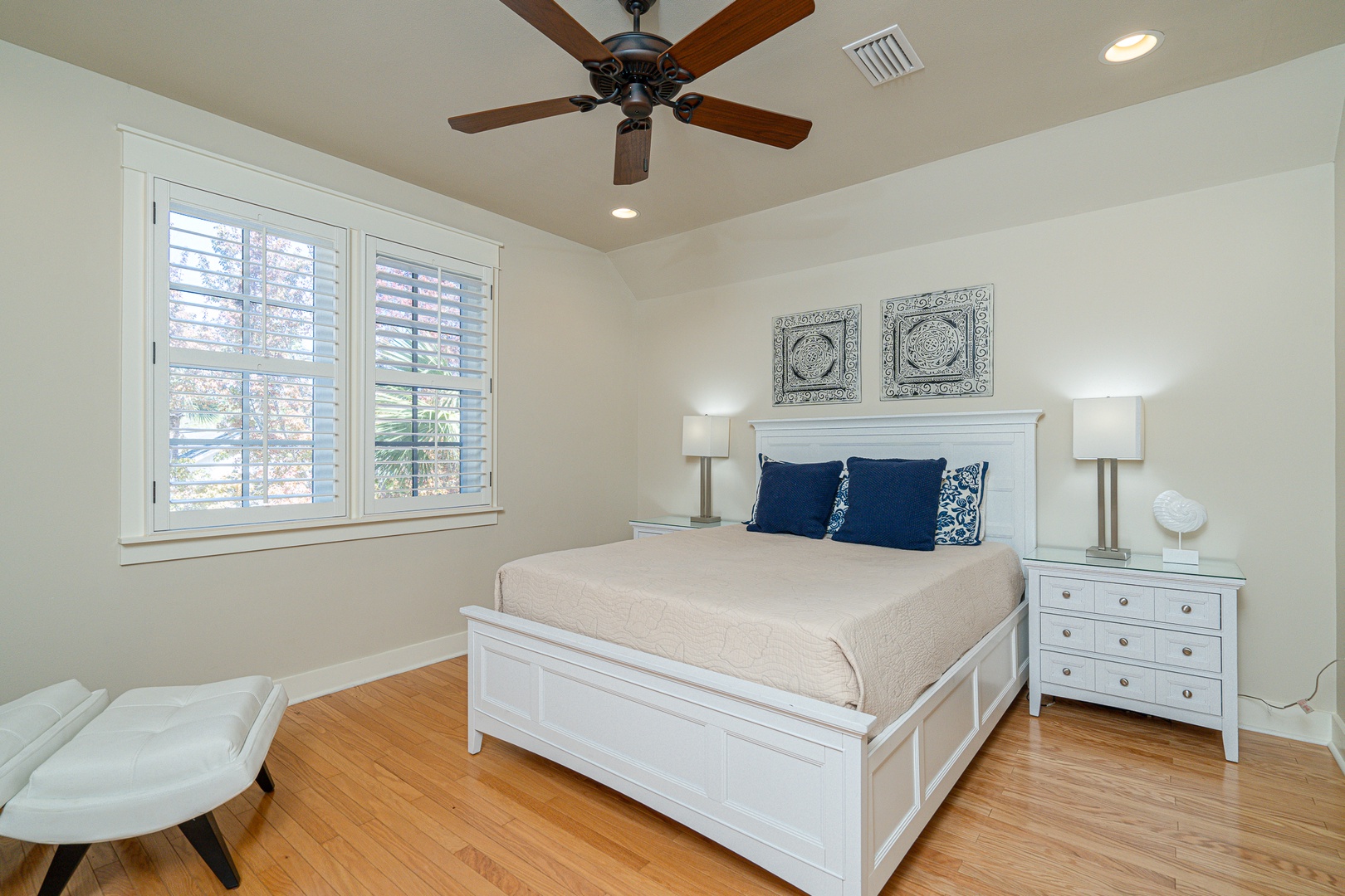 This 2nd-floor bedroom features a plush queen bed & private ensuite