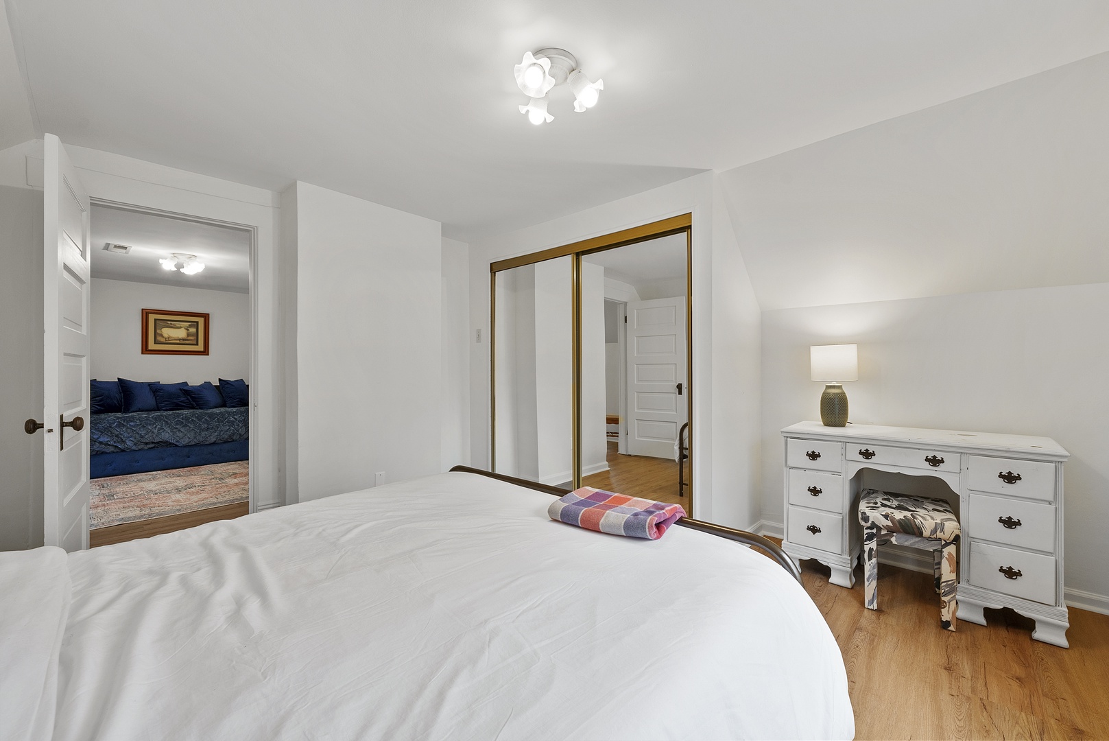The 2nd level bedroom features a queen-sized bed & desk workspace