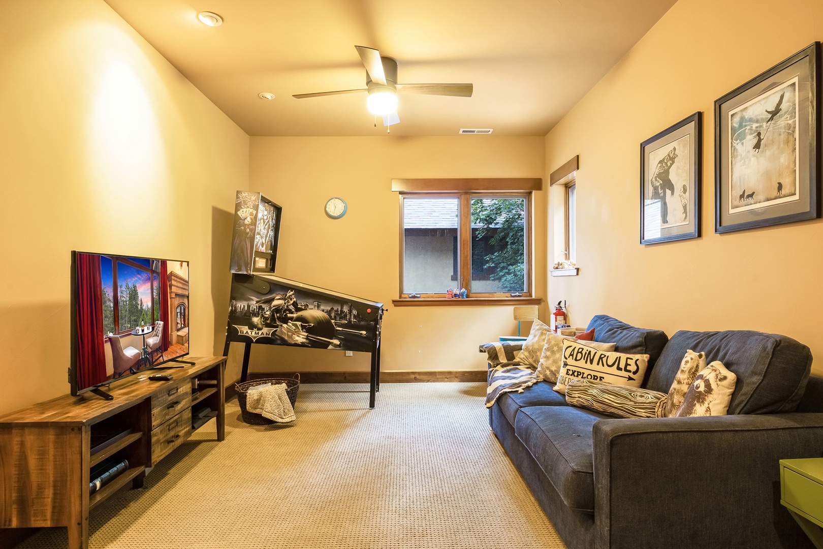 3rd floor game room with sofa sleeper, TV ,and pinball machine