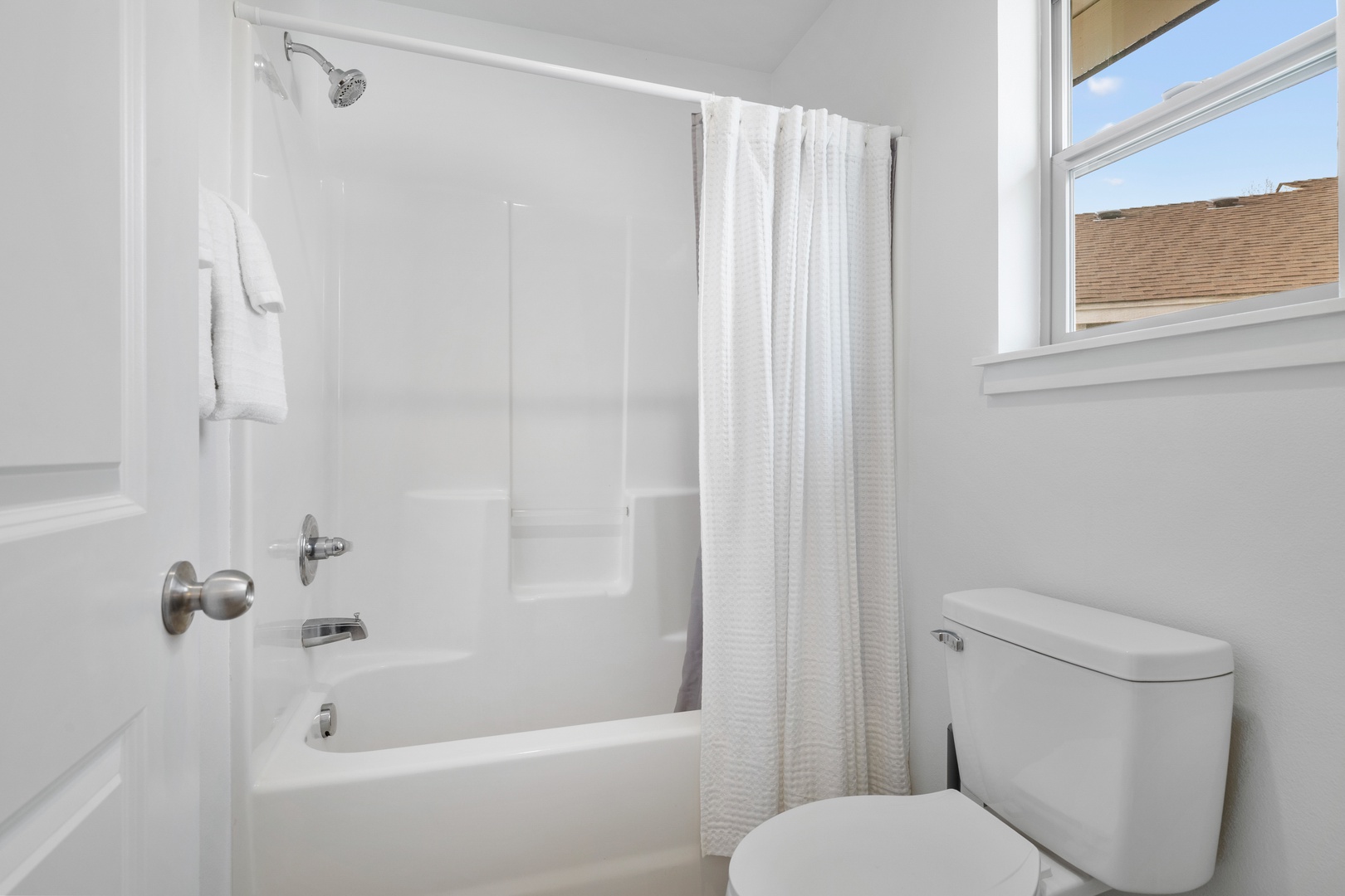 The 2nd floor hall bath offers a large vanity & shower/tub combo