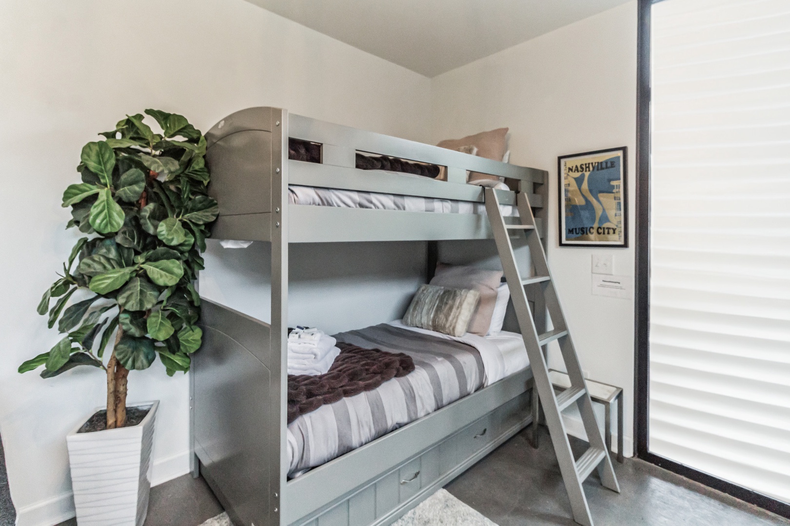 The chic first floor common area offers a twin-over-twin bunkbed
