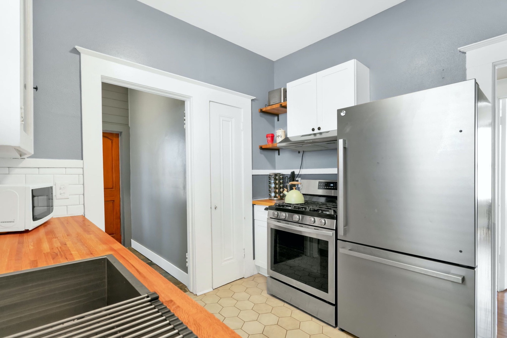 The breezy kitchen offers ample space & all the comforts of home