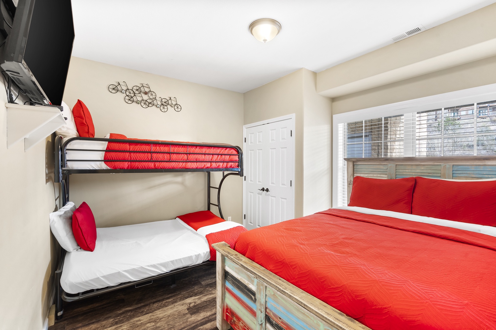 The third bedroom retreat boasts a queen bed, twin-over-full bunks, & a TV