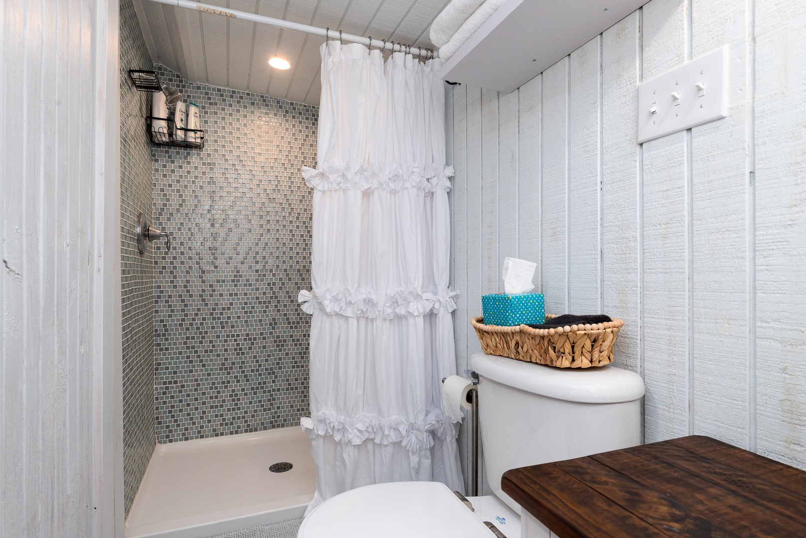The full bathroom offers closet space, a single vanity & walk-in shower
