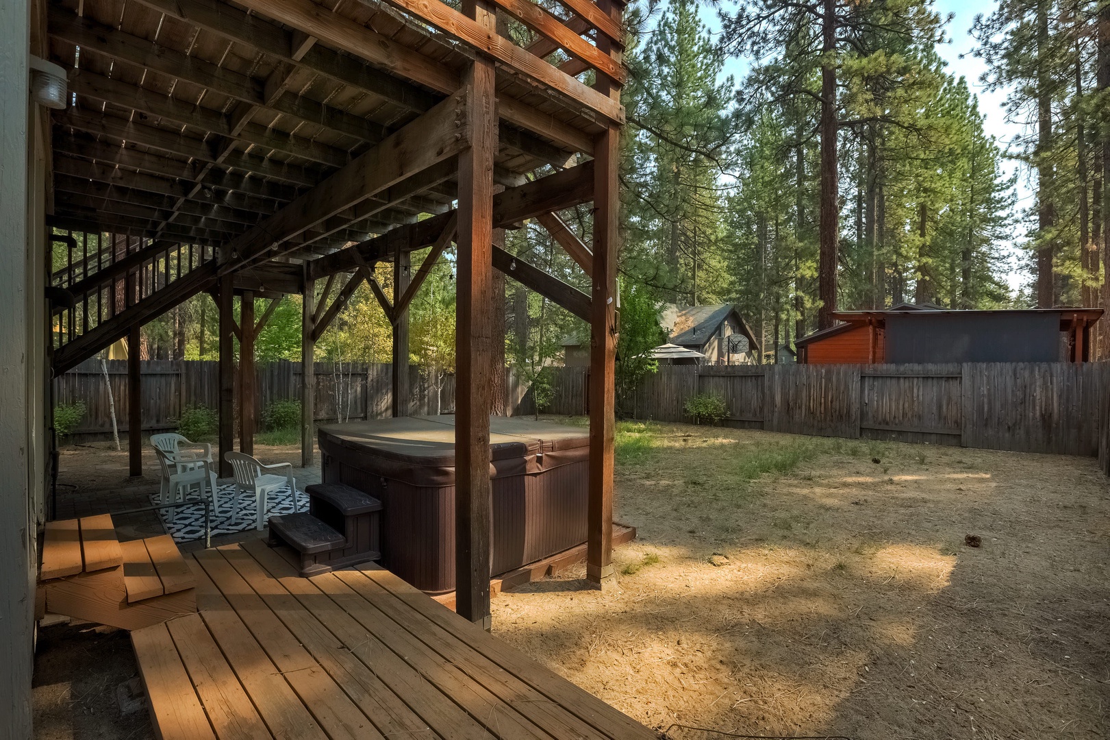 Gas BBQ, hot tub and seating in the backyard