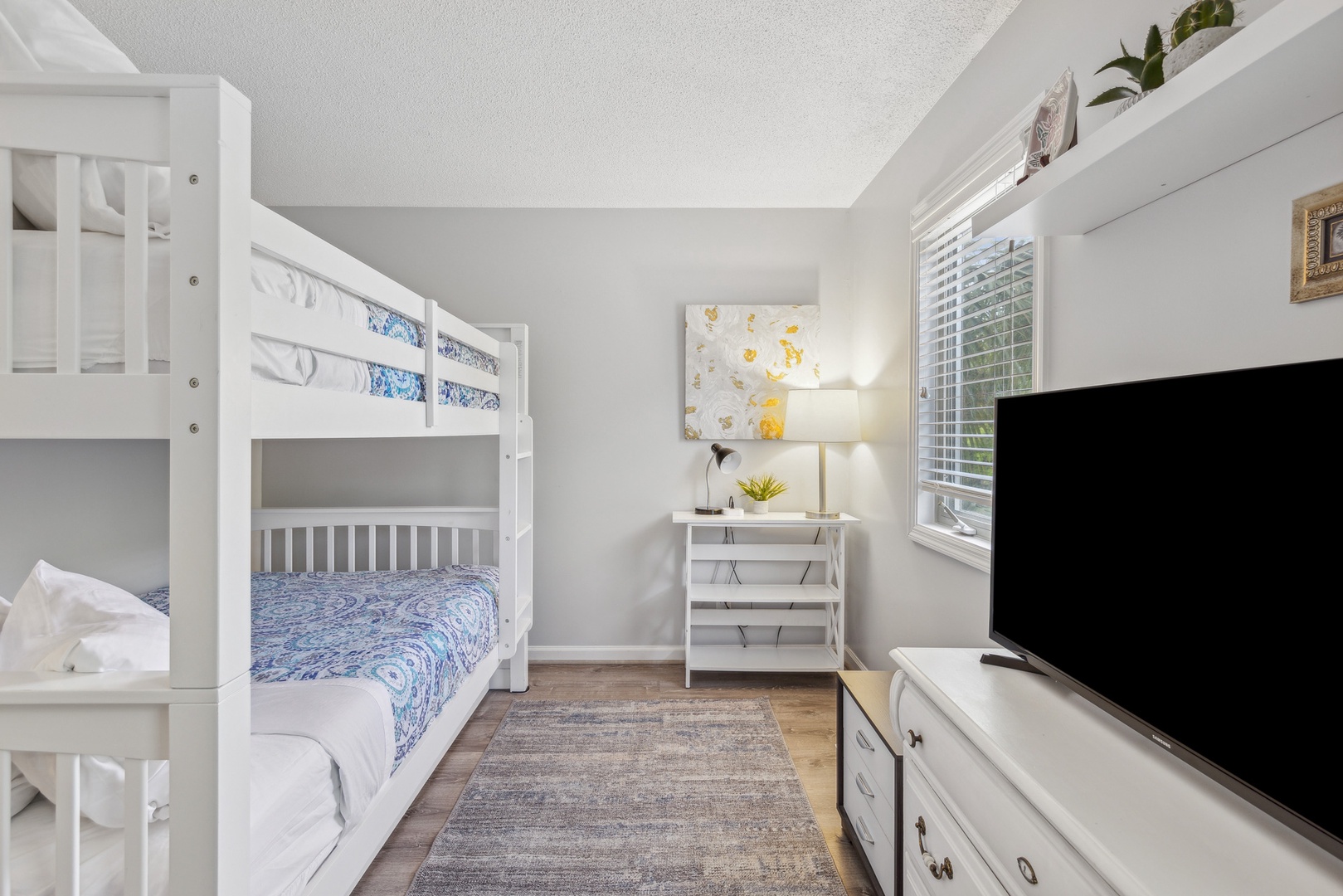 Relax in this cozy room featuring a full over full bunk bed, trundle & Smart TV