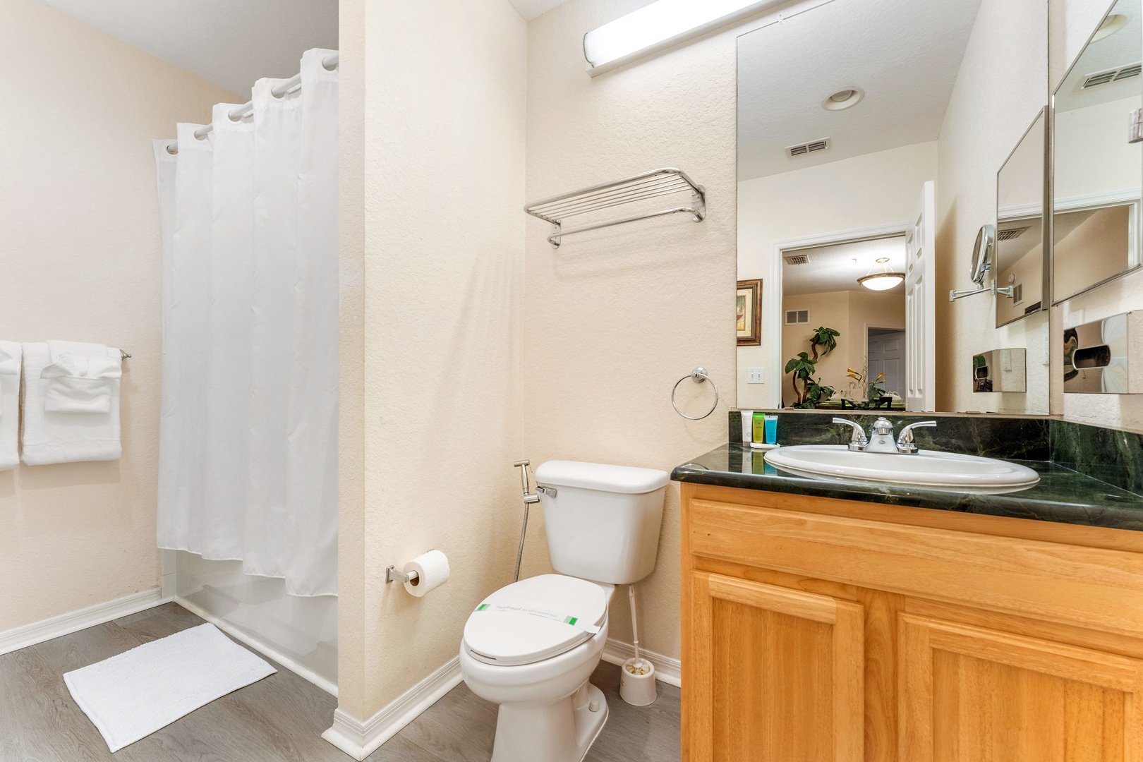 Wash up in this ensuite, featuring a single vanity & shower/tub combo