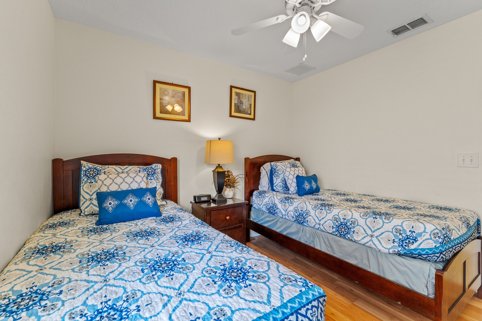 Double twin bedroom featuring a ceiling fan