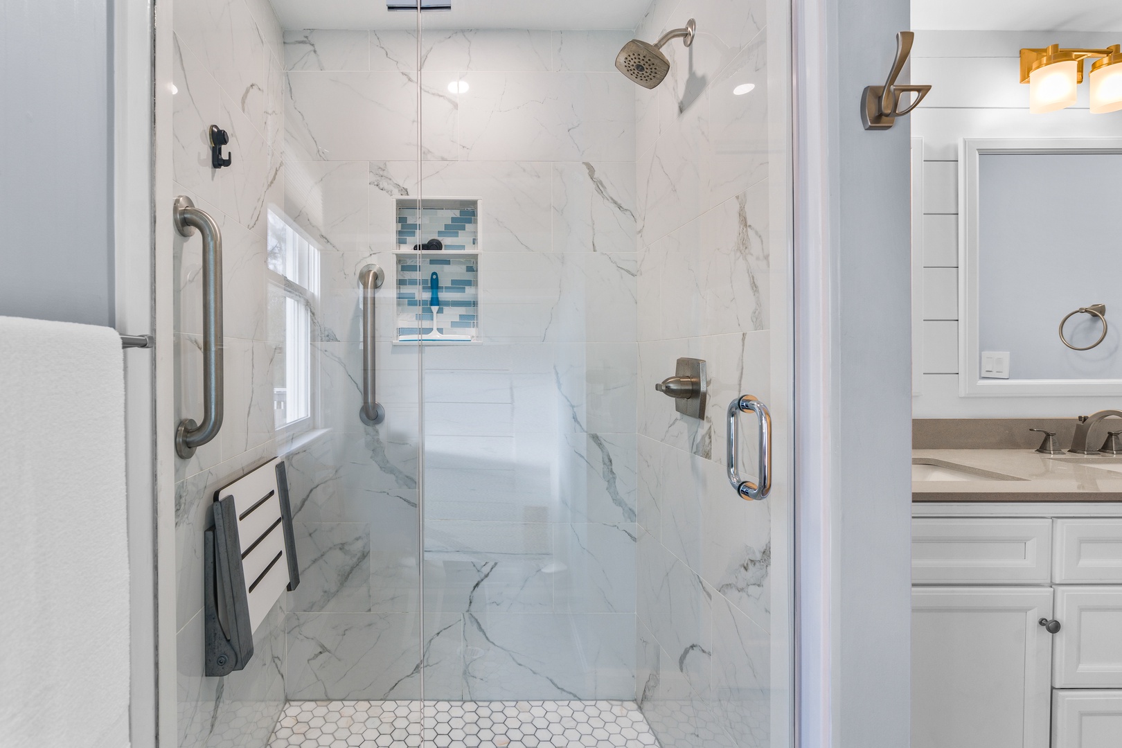 The full bath on the main level offers a double vanity & glass shower