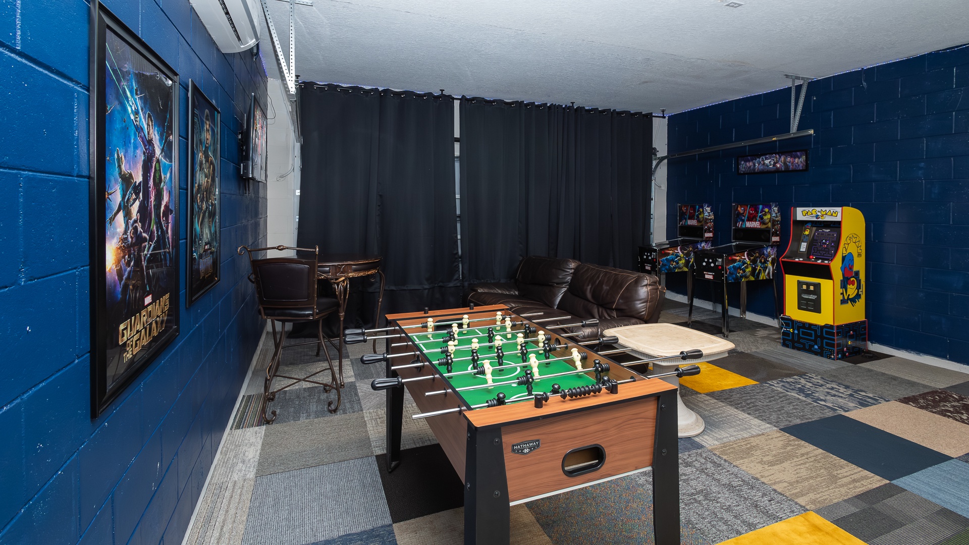 Marvel-themed game room fun: Pac-Man, foosball, and ping pong