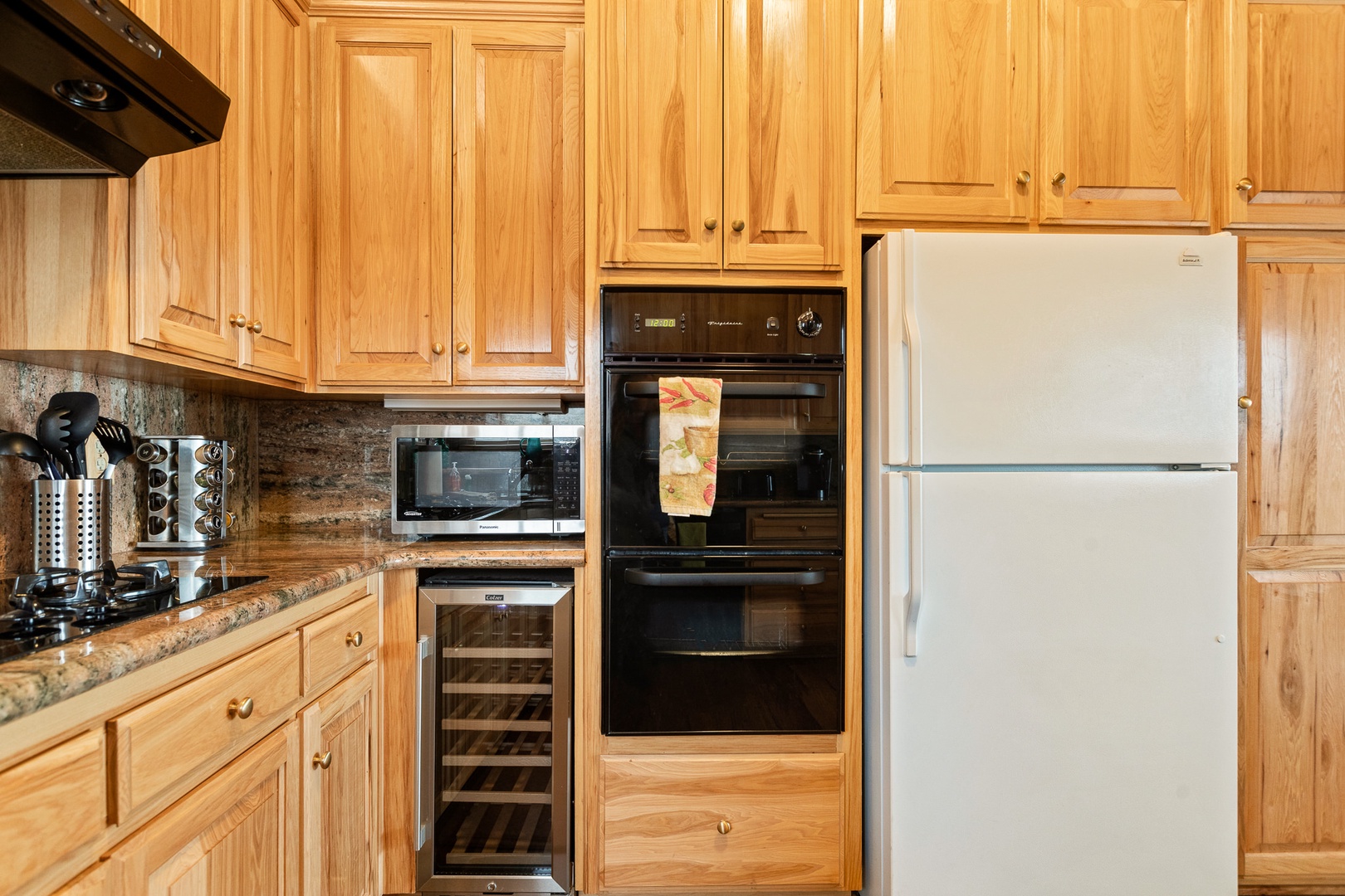 This kitchen offers dual ovens, wine fridge, and plenty of storage space for your stay