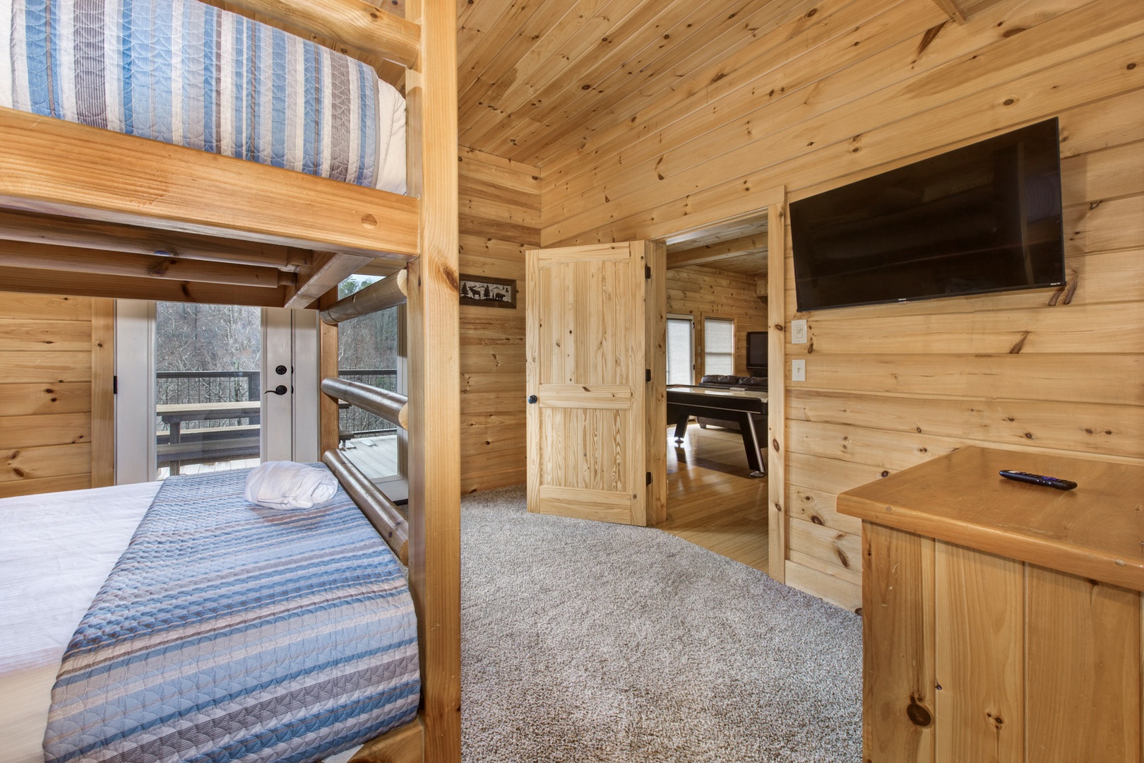 This lower-level retreat offers a private ensuite, Smart TV, & full over full bunks