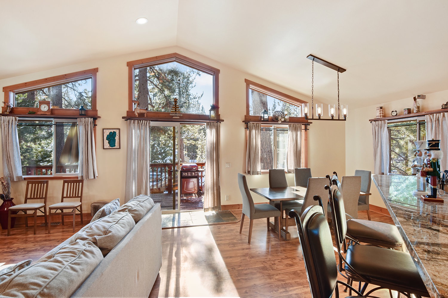 Open living space with gas fireplace, TV, and deck