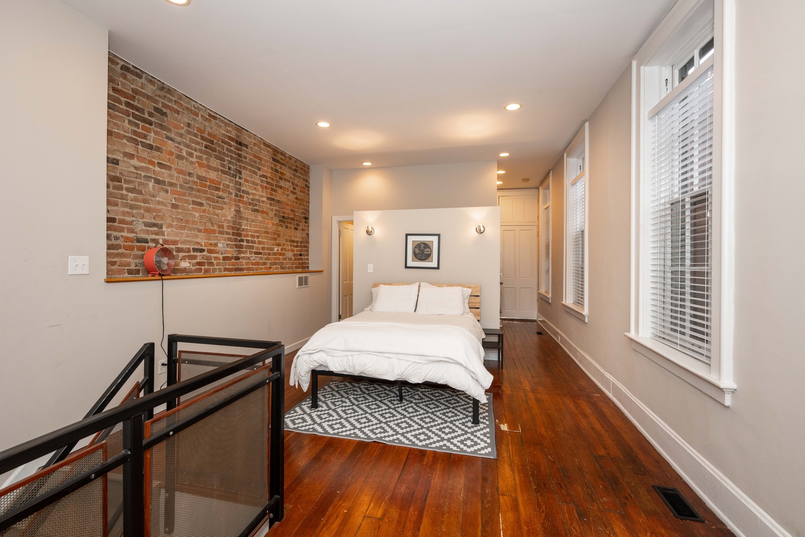The loft sleeping area boasts a plush queen bed, ensuite, & laundry access