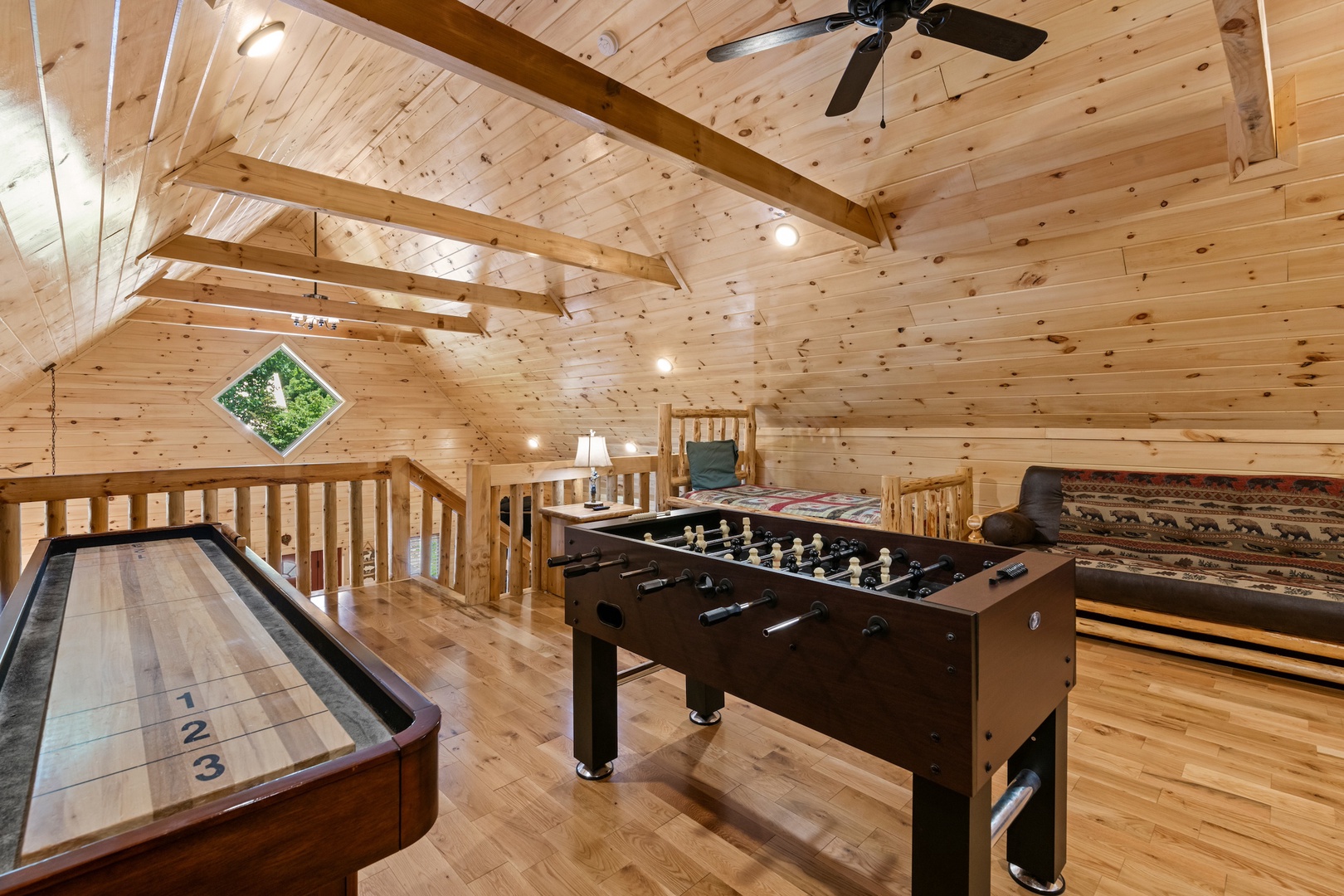 Game & relax in the loft, offering a futon & twin bed/trundle combo