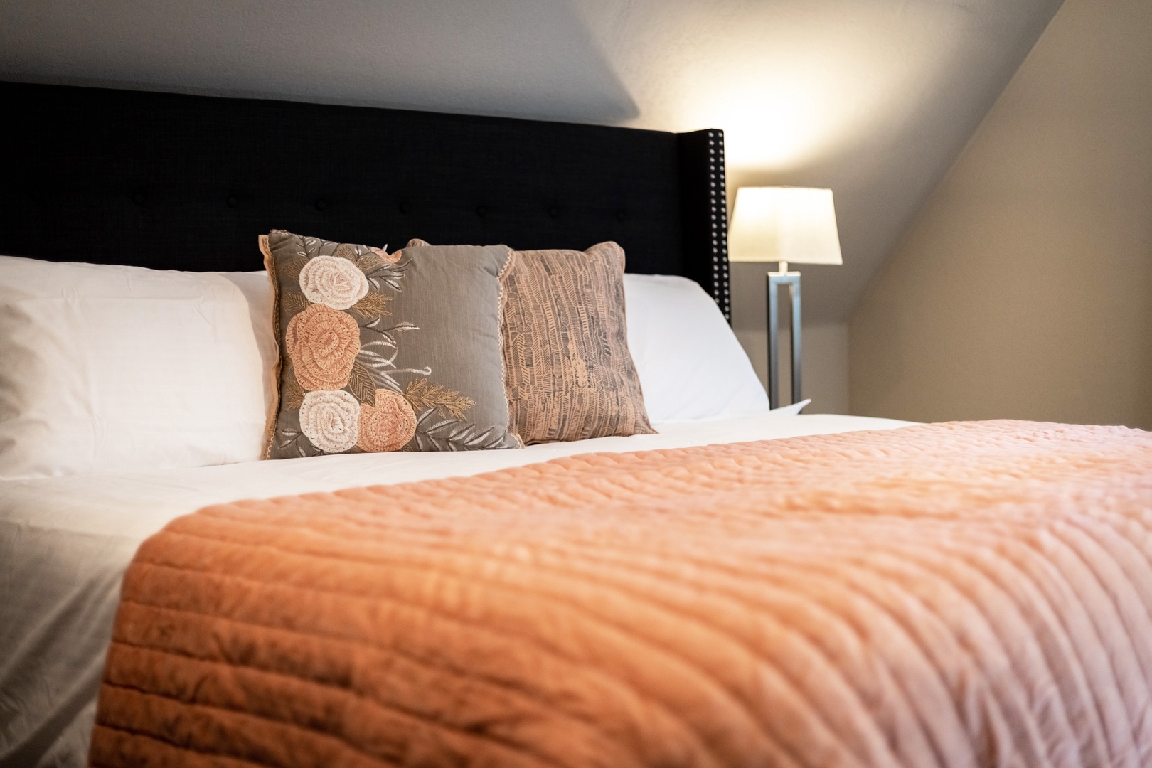 The 2nd-floor king bedroom includes a cozy sitting area & en suite bathroom