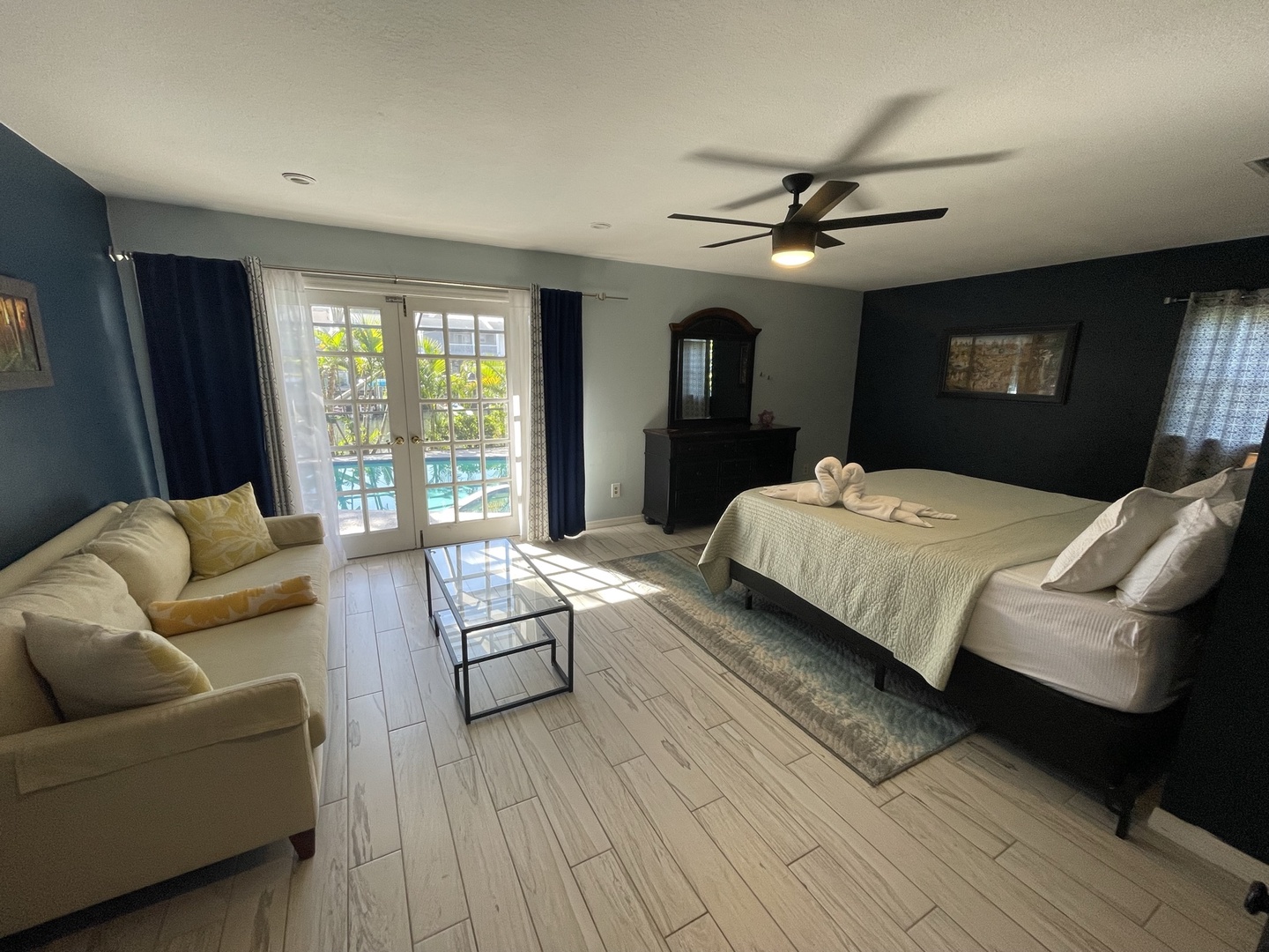 The king suite boasts a loveseat, private ensuite, & patio access