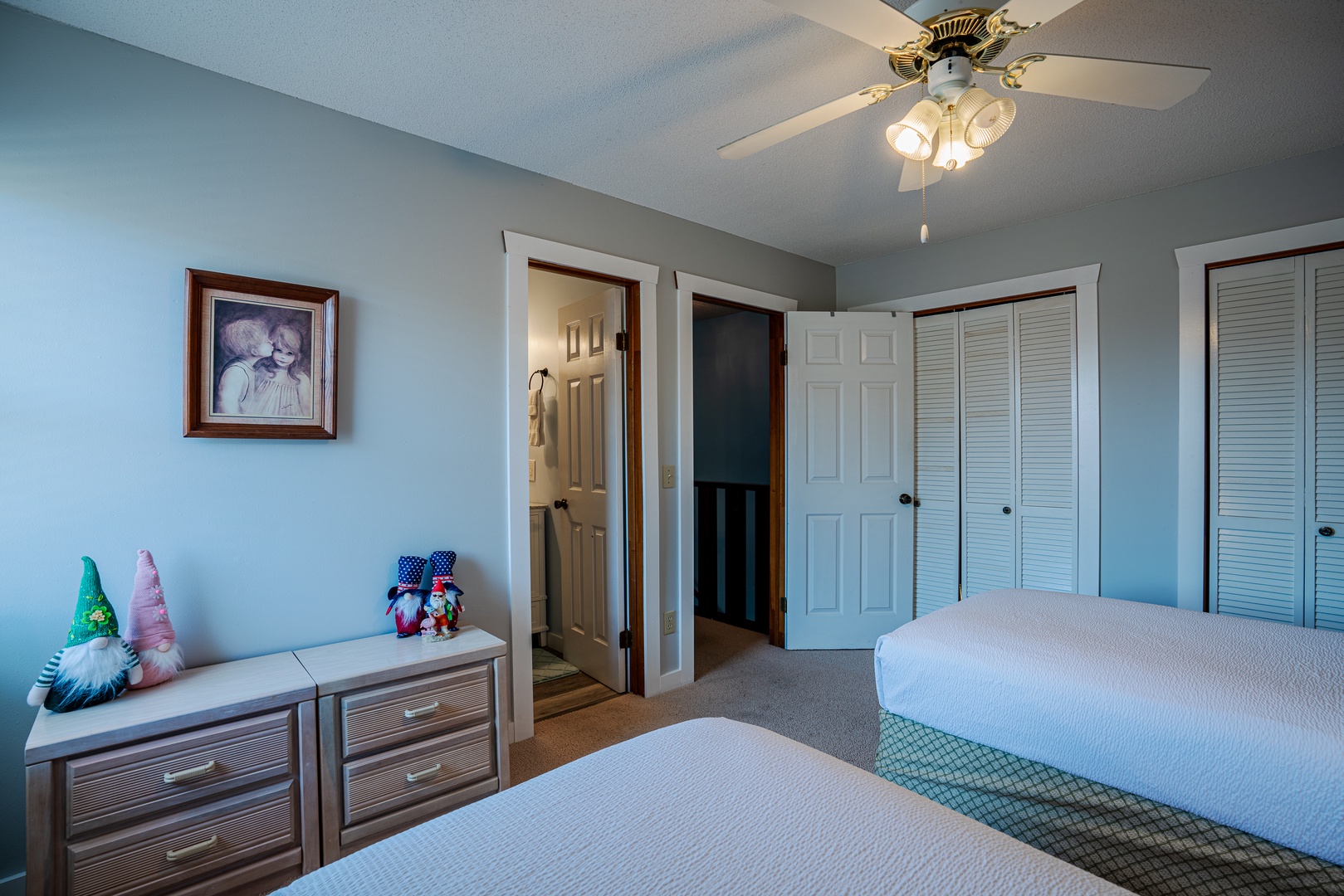 This serene double twin bed suite boasts a private ensuite with ceiling fan