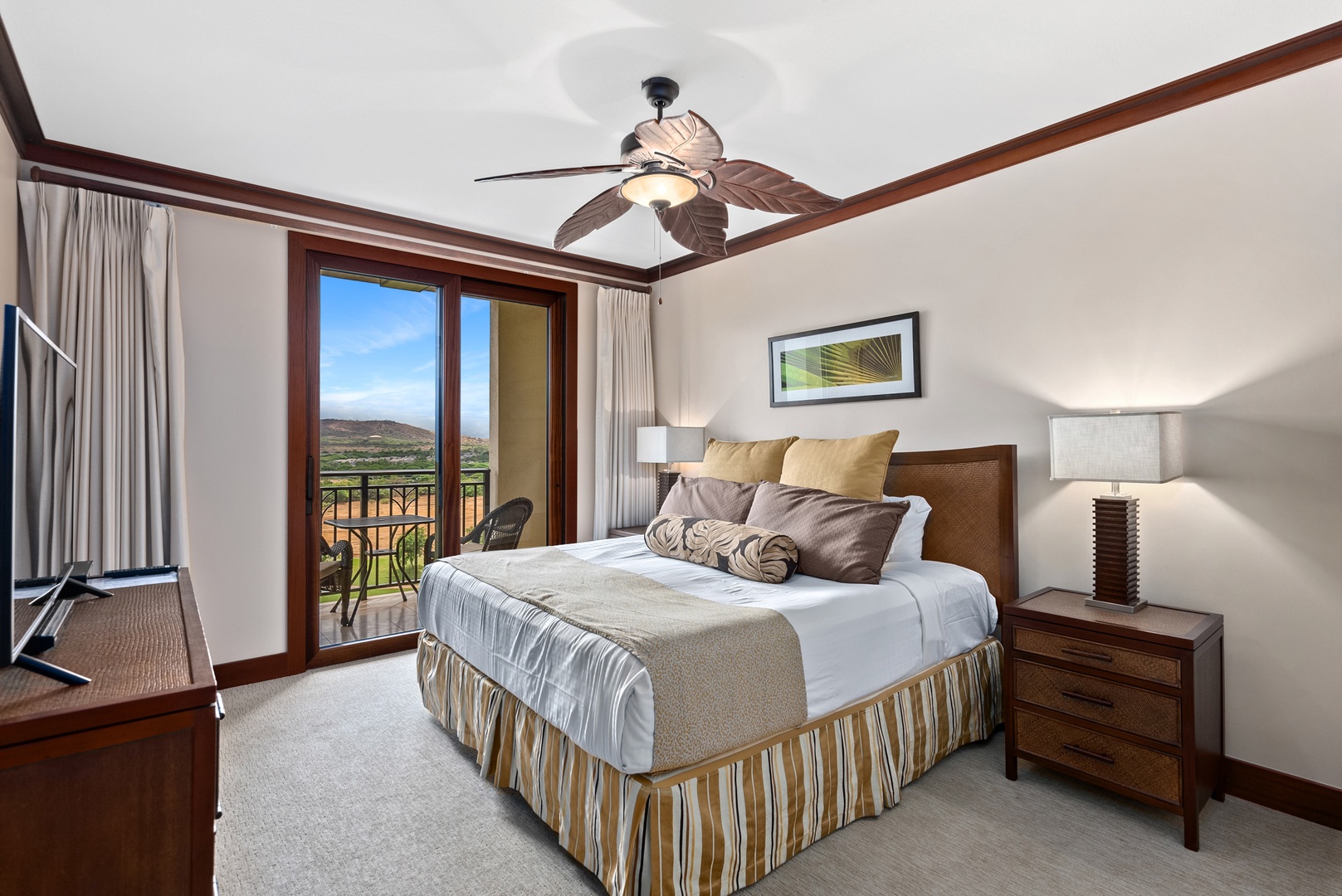 The primary bedroom features a king bed and private balcony access