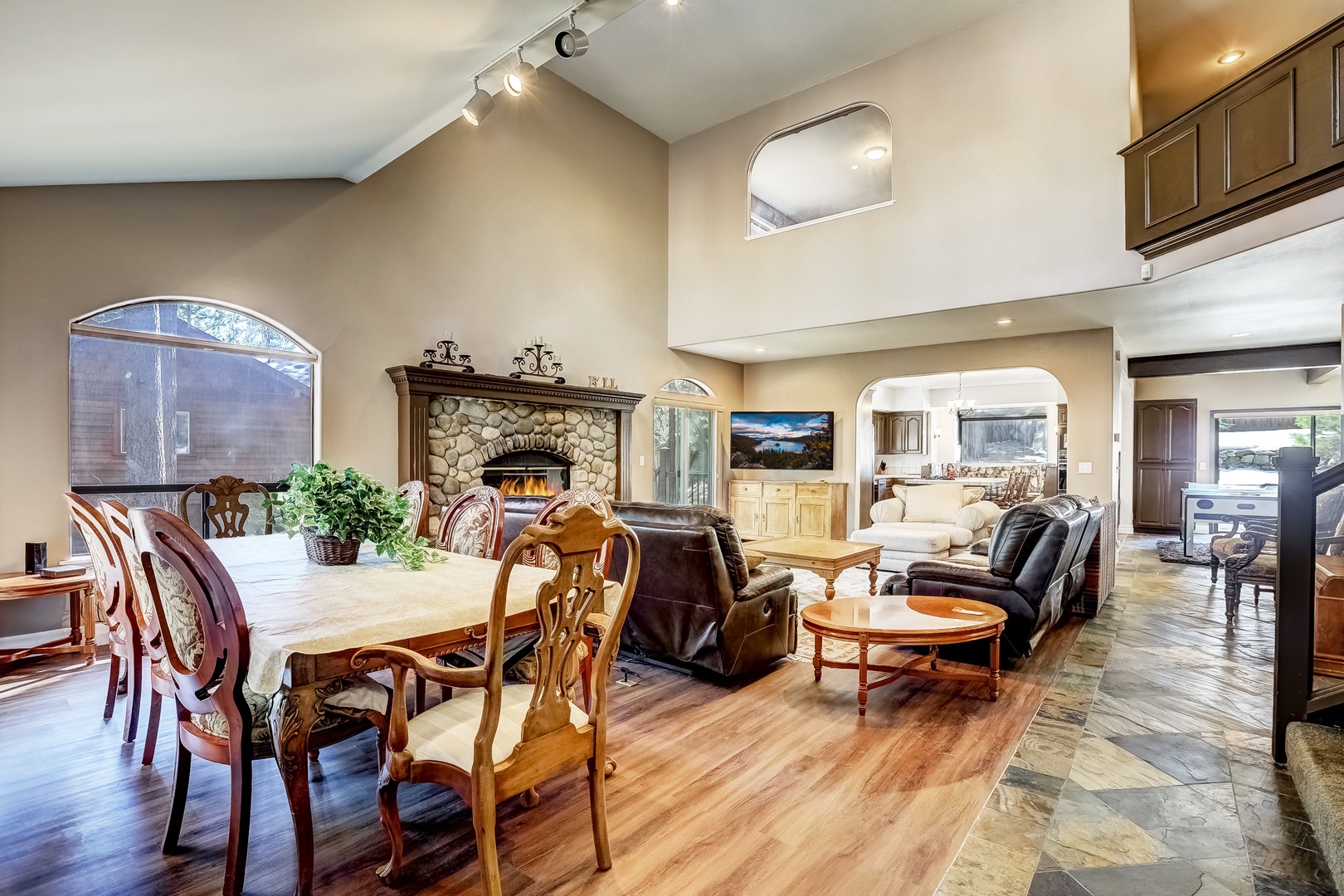 Living room with Samsung Smart TV, wood burning fireplace, and plenty of seating