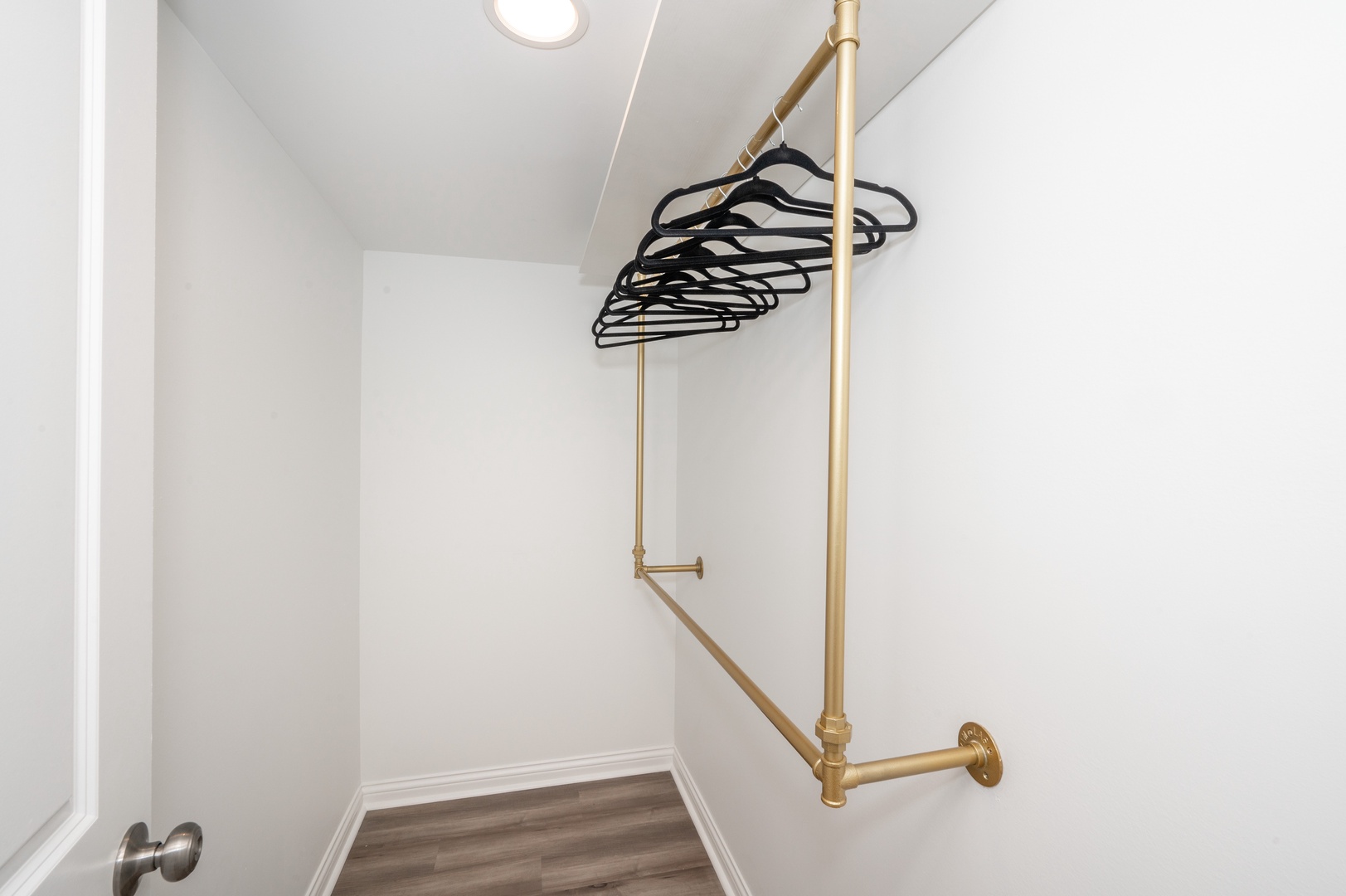 The bedroom closet offers plenty of space to keep bags and clothes neatly tucked away