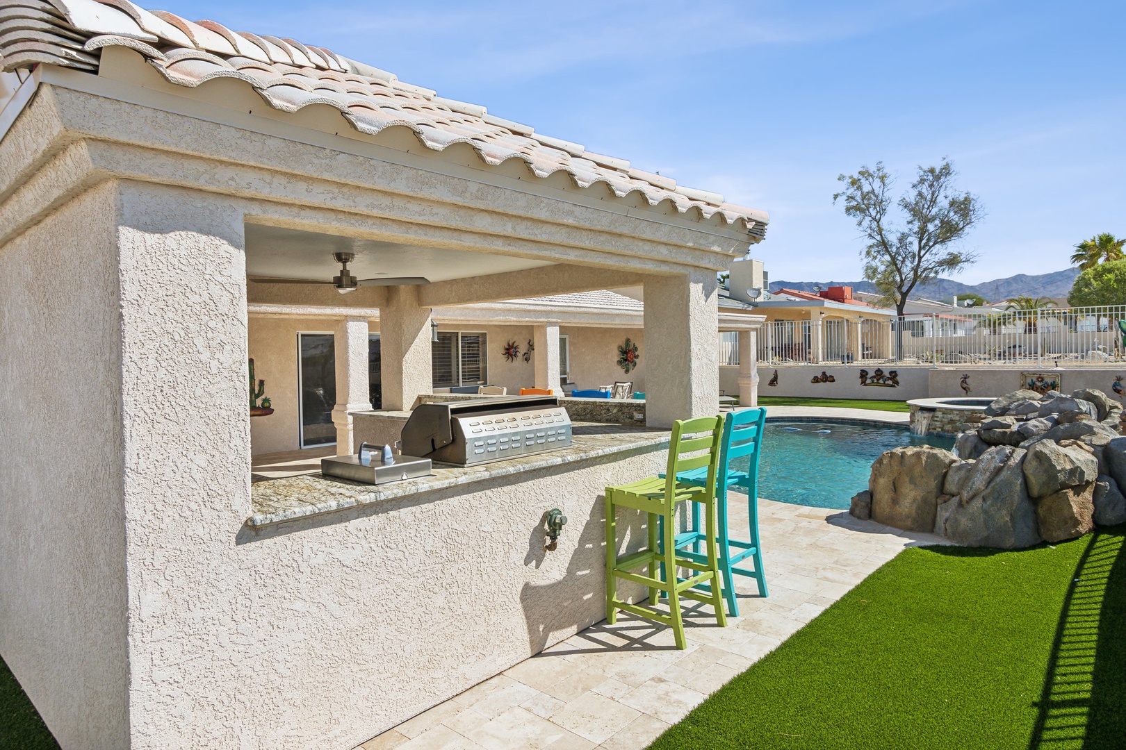 A mountain-view oasis, with a waterfall pool, hot tub, & outdoor kitchen!