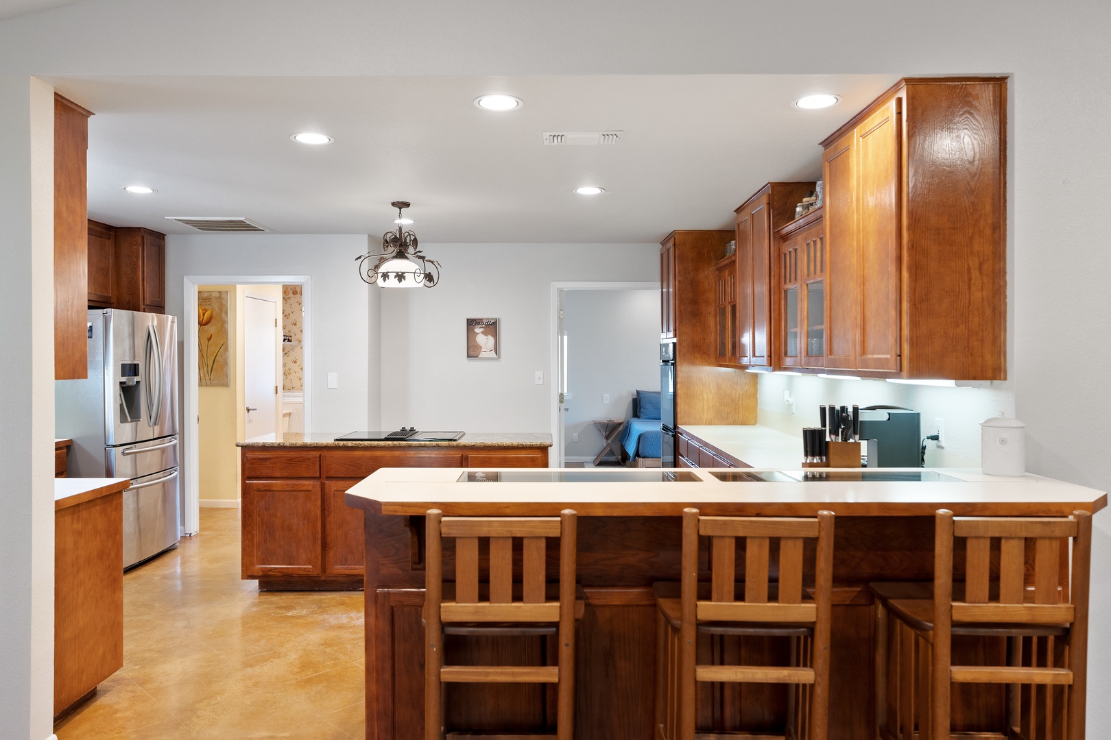 The kitchen is spacious and open, offering counter seating for 3