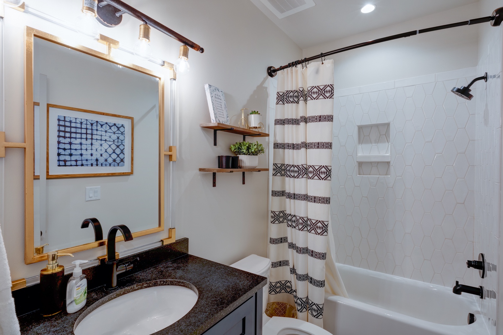 The full bathroom offers a stylish shower/tub combo