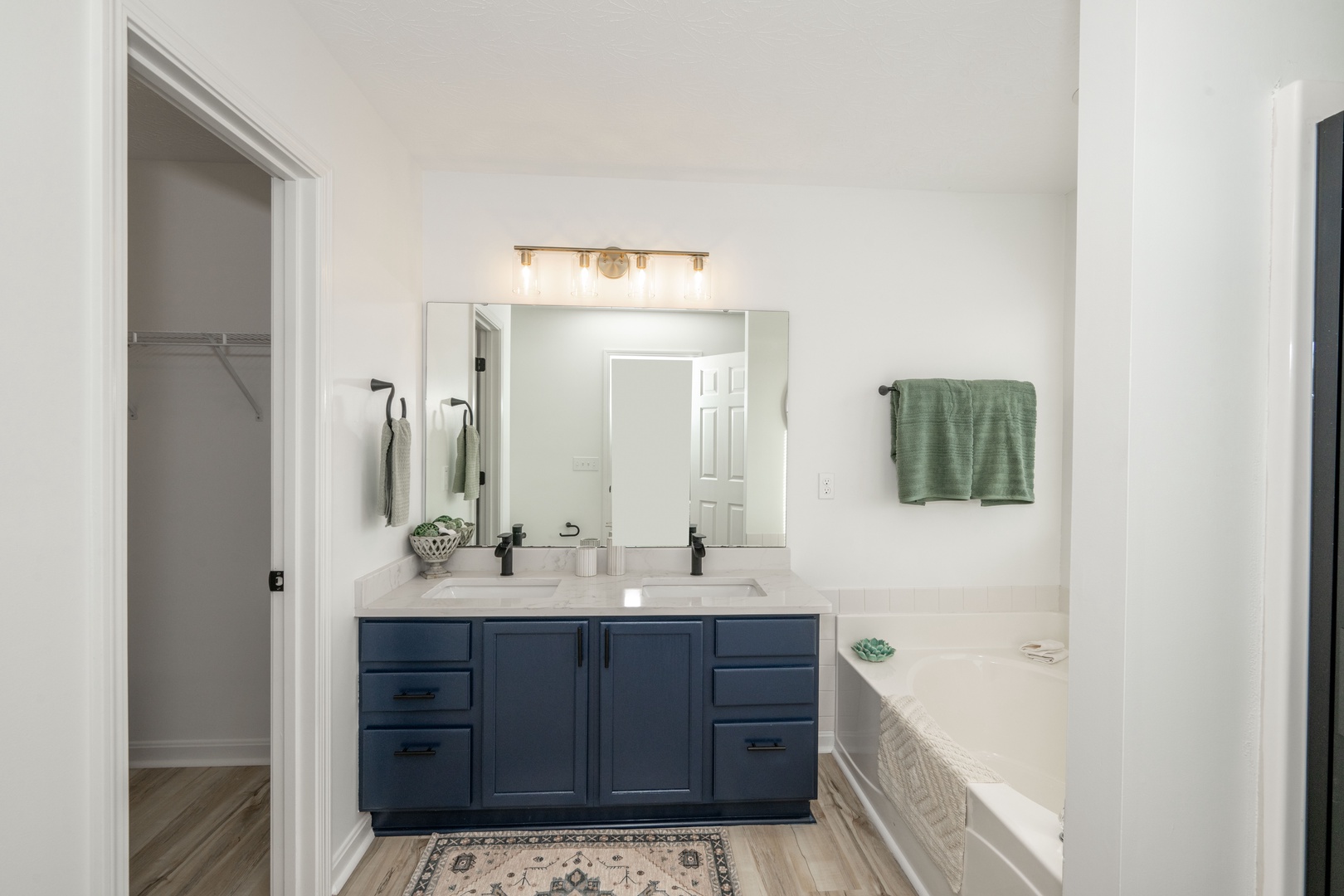 This full ensuite offers a double vanity, closet, soaking tub and shower