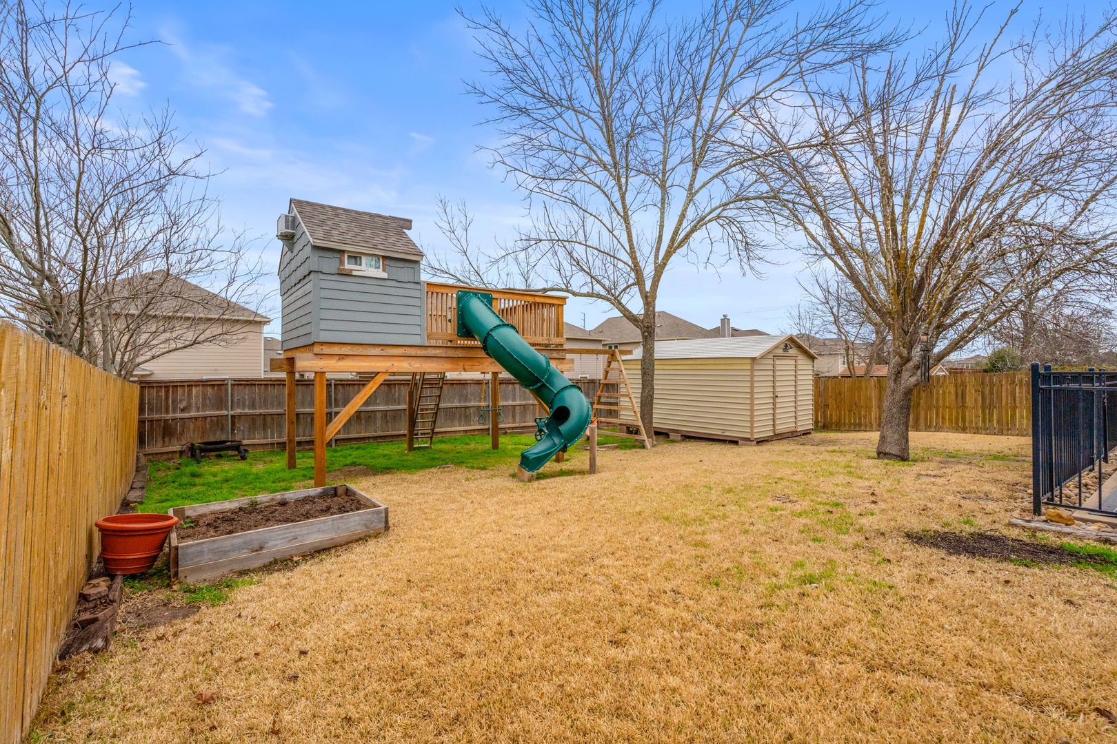 The backyard playground equipment/clubhouse is sure to be a hit with littles!