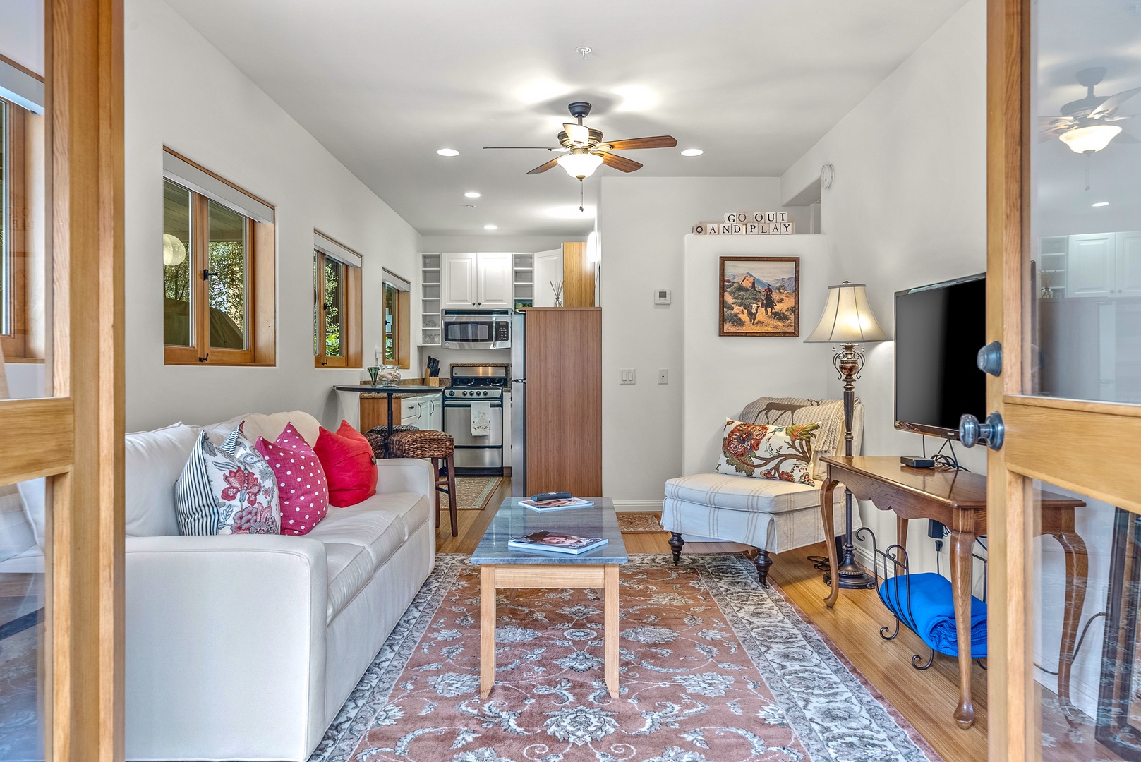 Bright living area with cozy seating and Smart TV