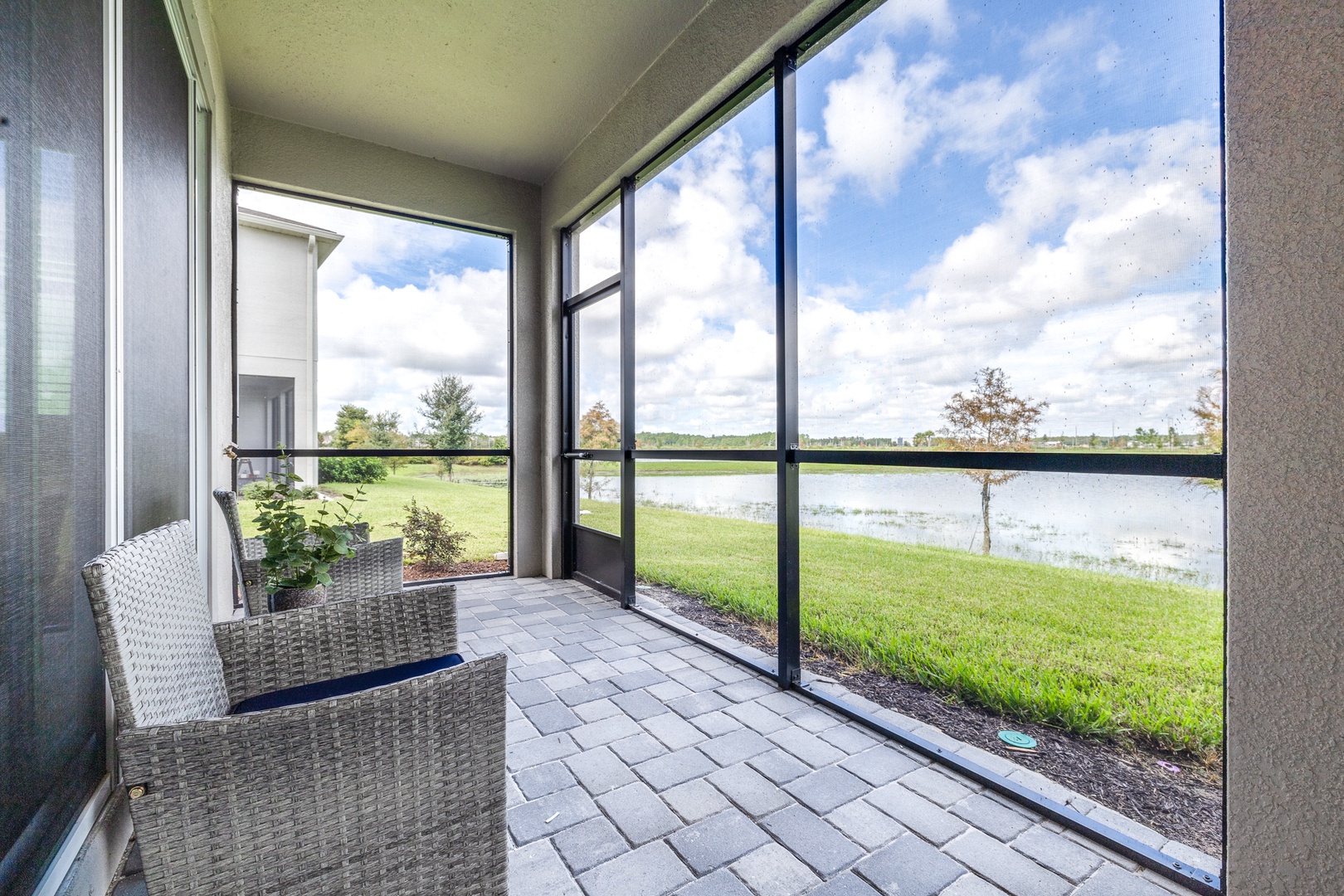 Relax with a drink on the covered back patio while enjoying the waterfront view