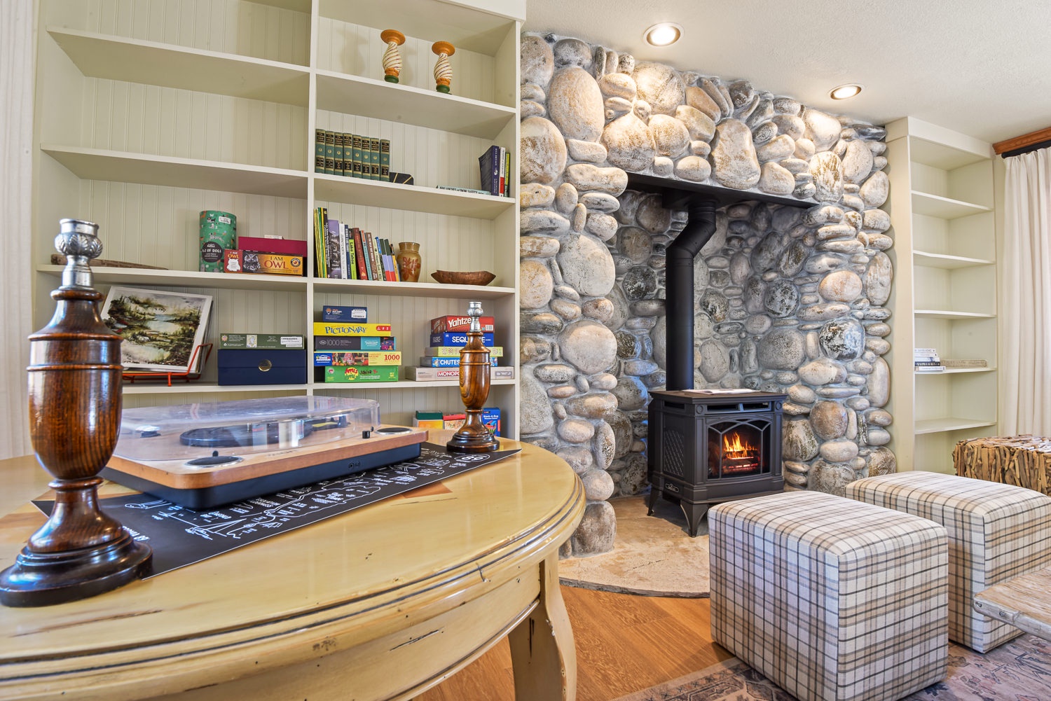 Game room featuring a chess table, a collection of games, and a cozy gas fireplace