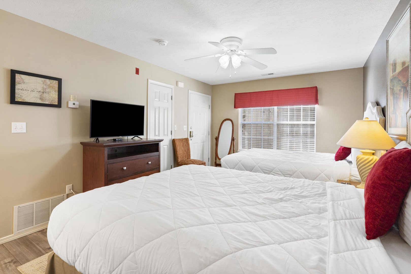 Double Queen Bedroom with ceiling fan, En Suite Bathroom, and TV