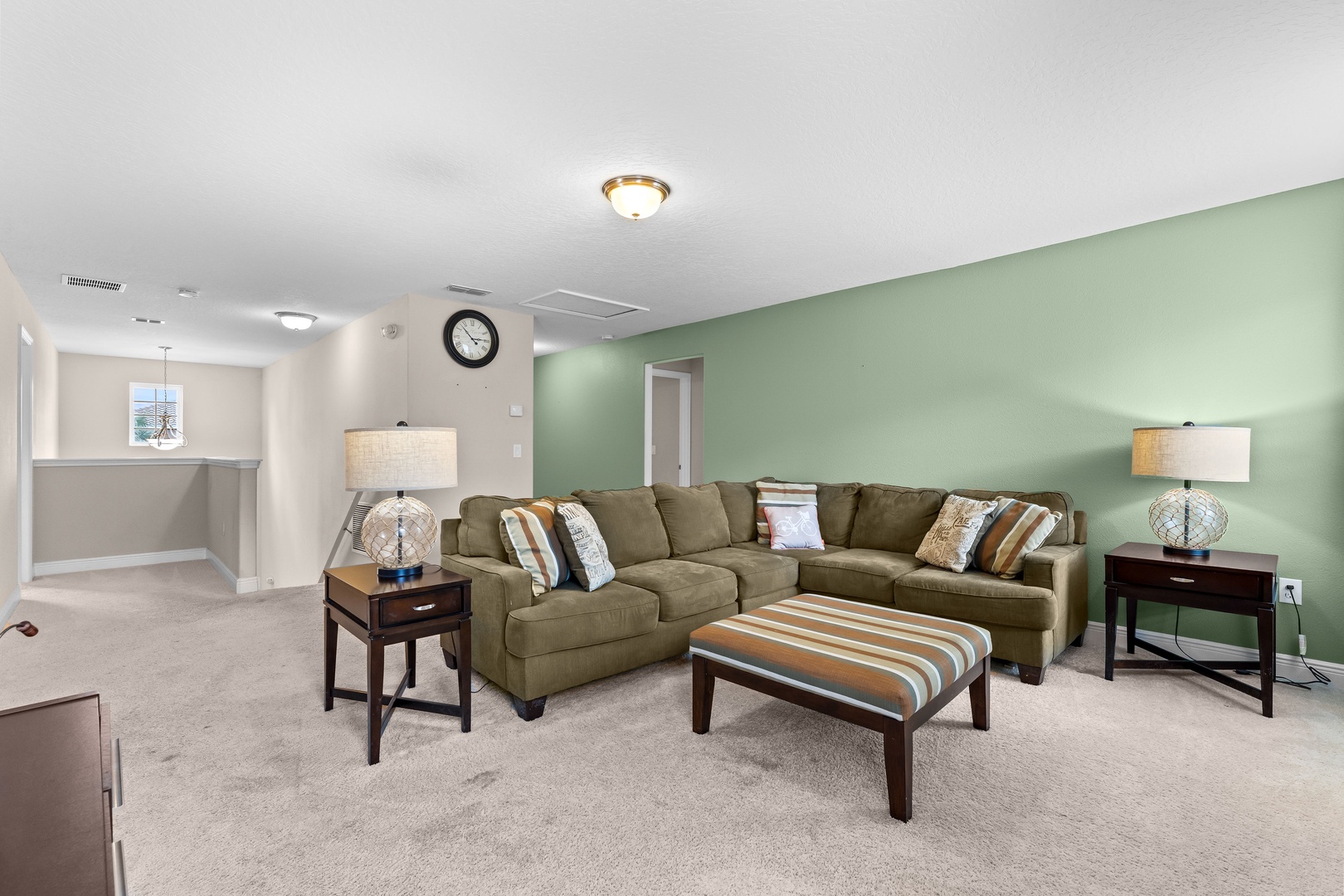 Second floor living area with sectional seating and Smart TV
