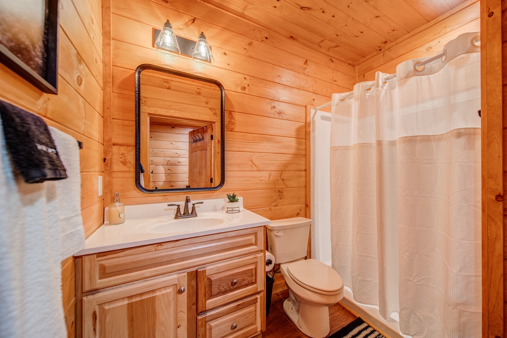 The lower-level full bathroom includes a single vanity & walk-in shower