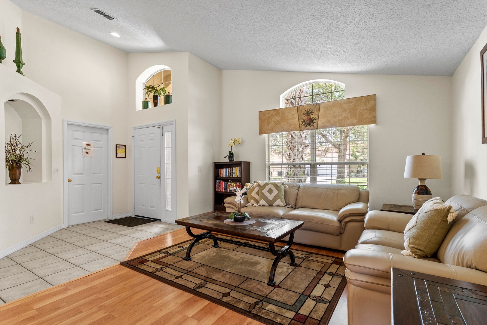 Front living room with a full-size sleeper sofa and dining area for 6