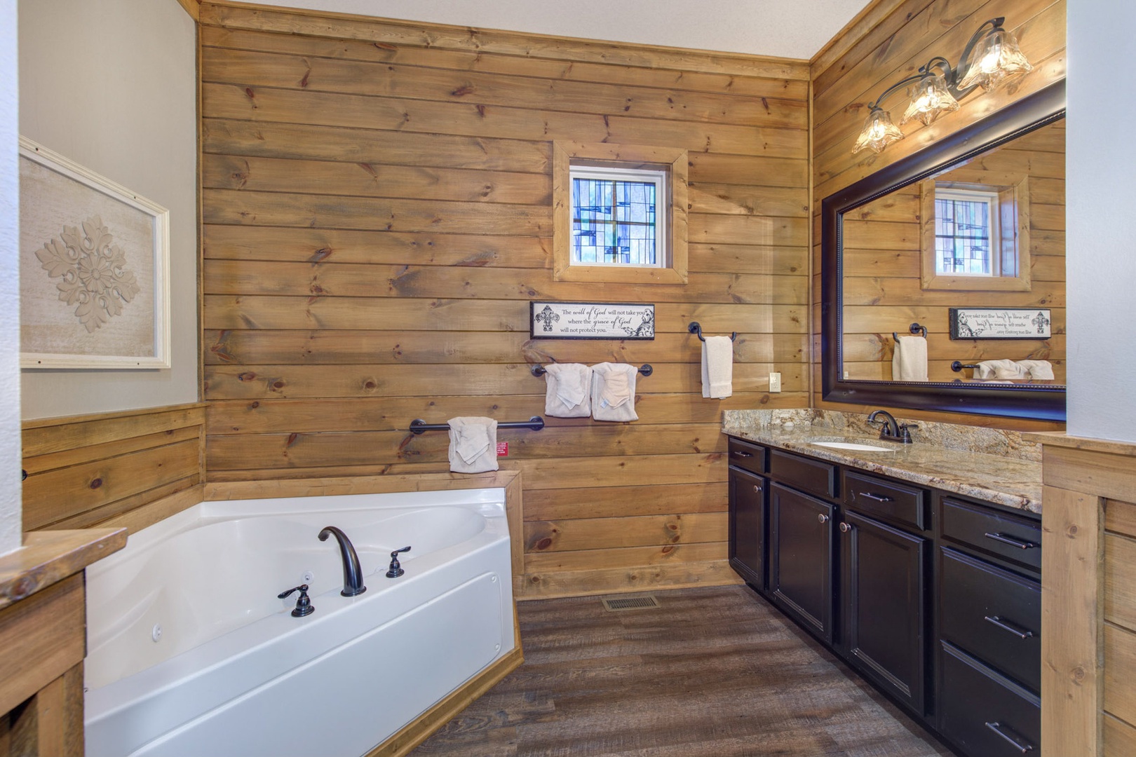 This ensuite bath offers an oversized vanity, shower, & soaking tub