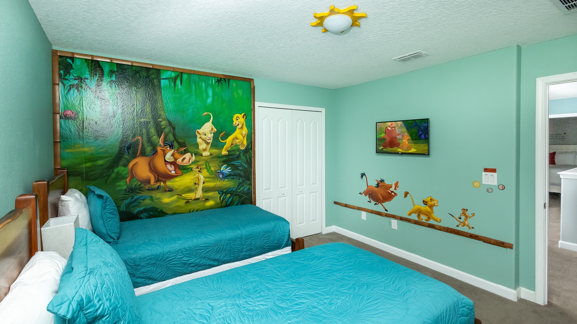 Bedroom 6 Lion King themed with 2 twin beds, Smart TV, and shared ensuite