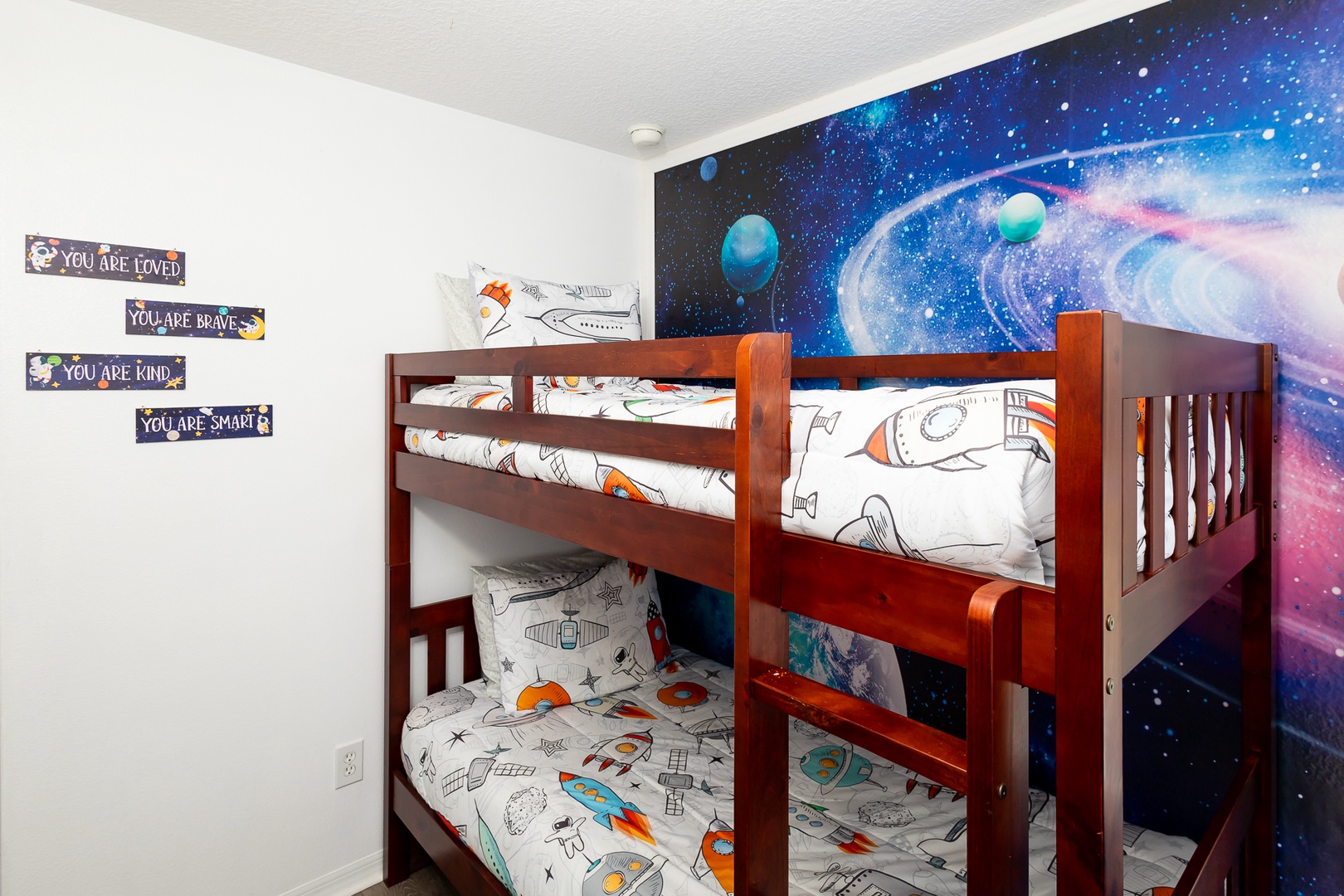 Relax in the cosmic bunk bed retreat, with 2 twin bunkbeds & Smart TV
