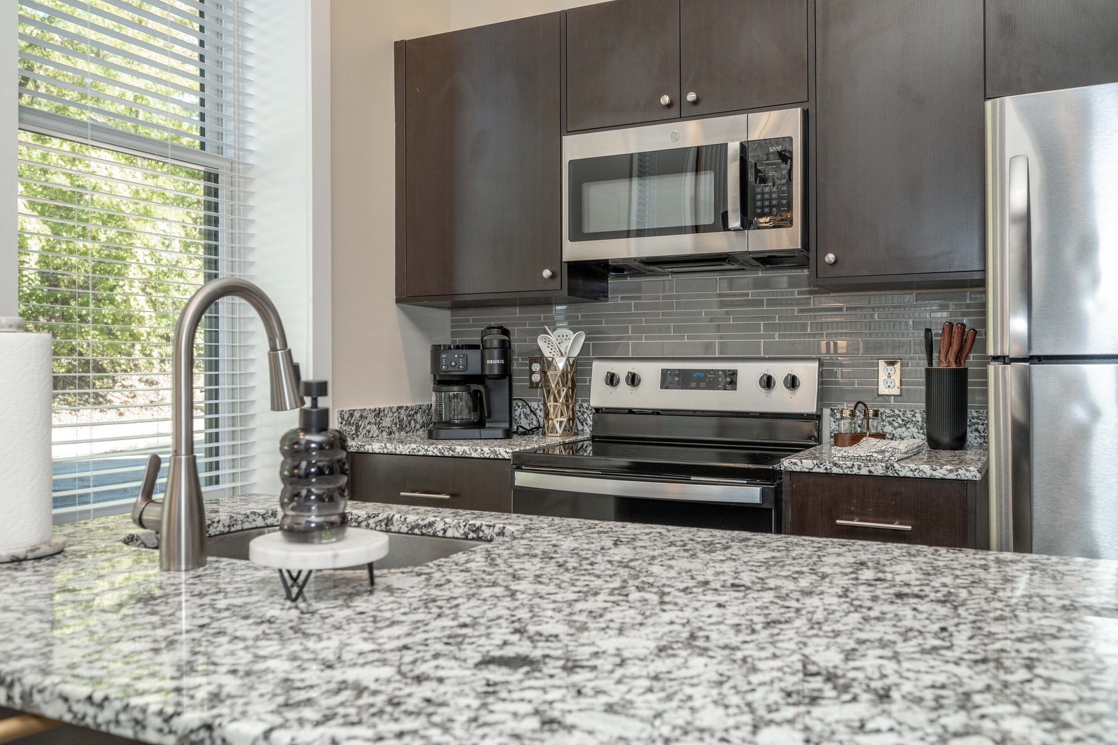 The chic, open kitchen offers loads of room & all the comforts of home