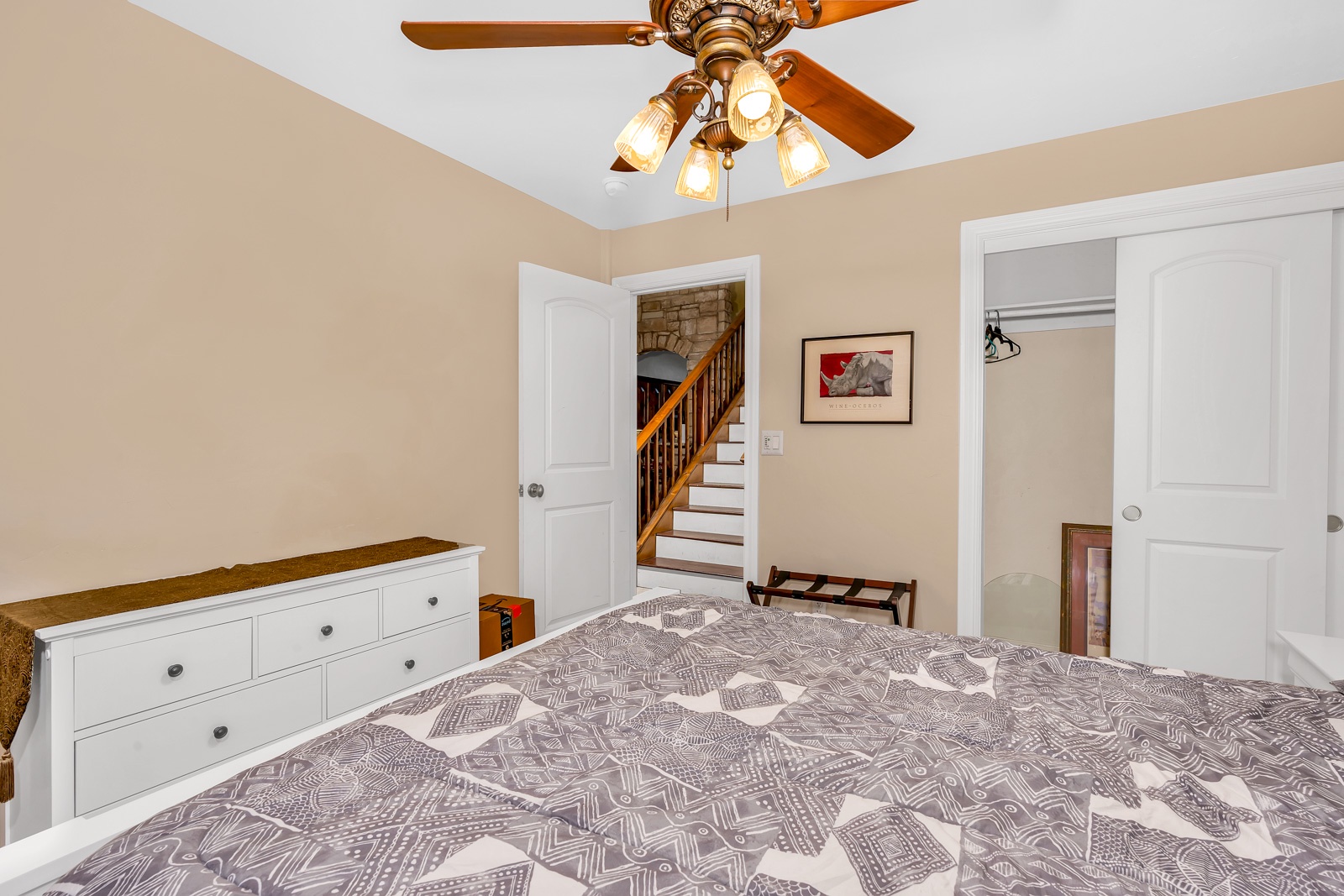This 1st floor bedroom includes a queen bed, large closet, & ceiling fan