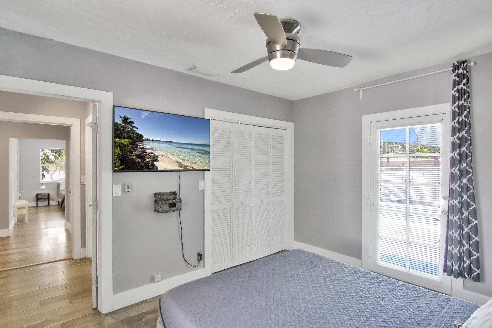 This cozy queen bedroom offers a Smart TV & access to the pool area