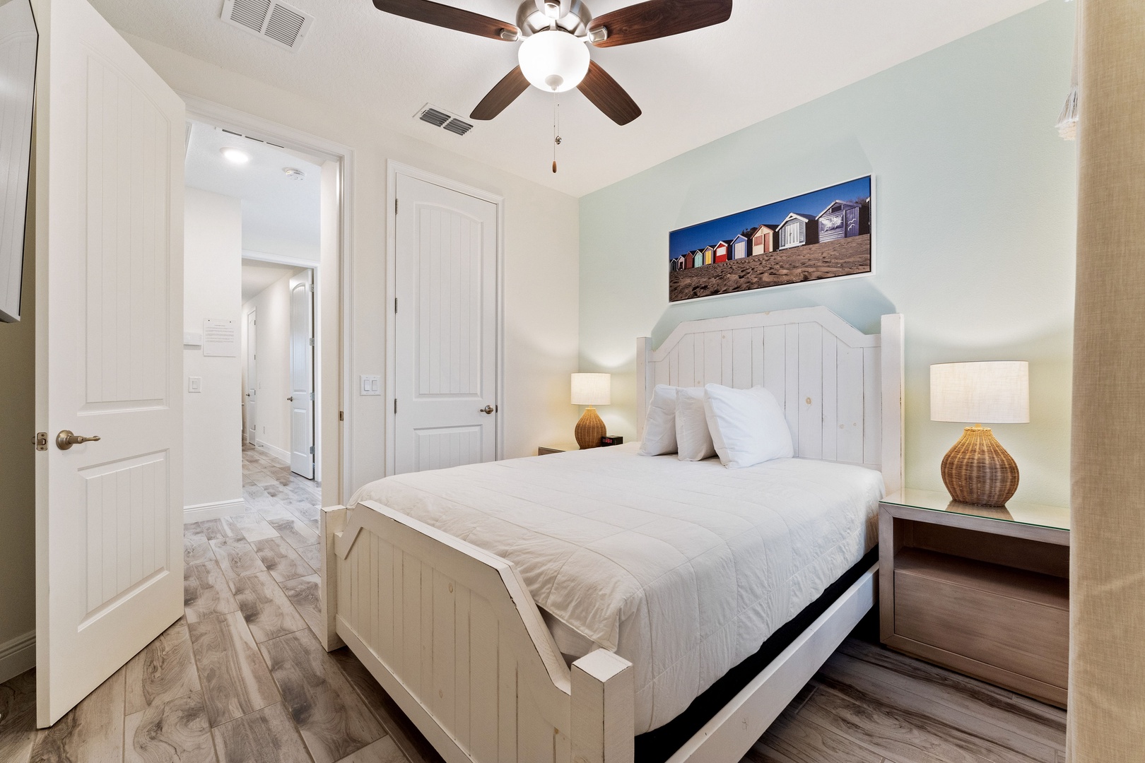 The beachy 2nd floor queen bedroom includes & Smart TV & organized closet