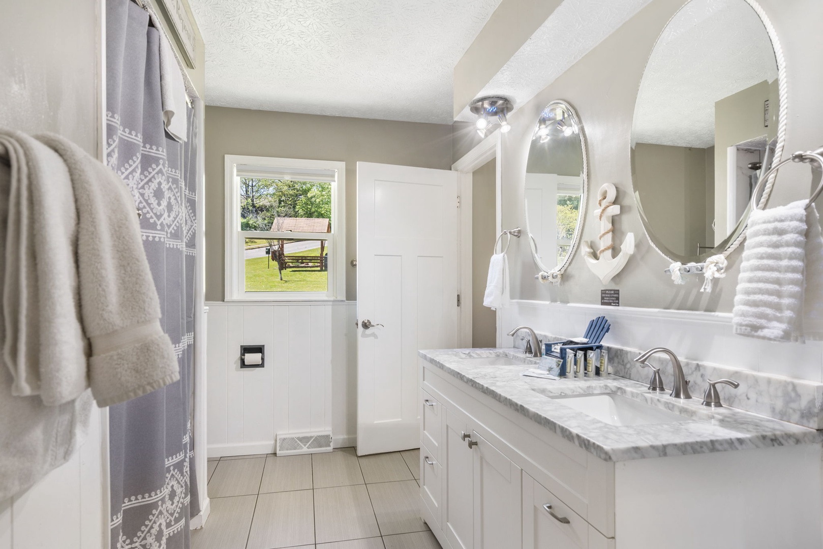 The king en suite bathroom offers a double vanity & shower/tub combo