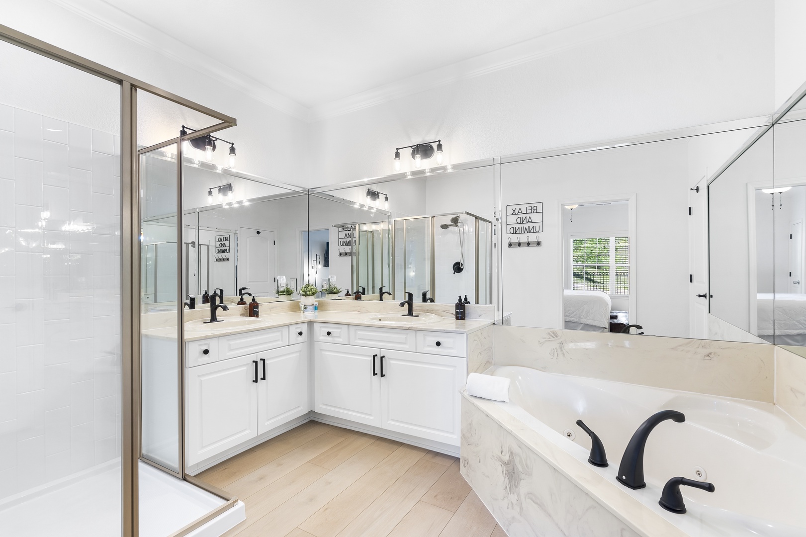 King ensuite boasts a large double vanity, standing shower and a jetted tub