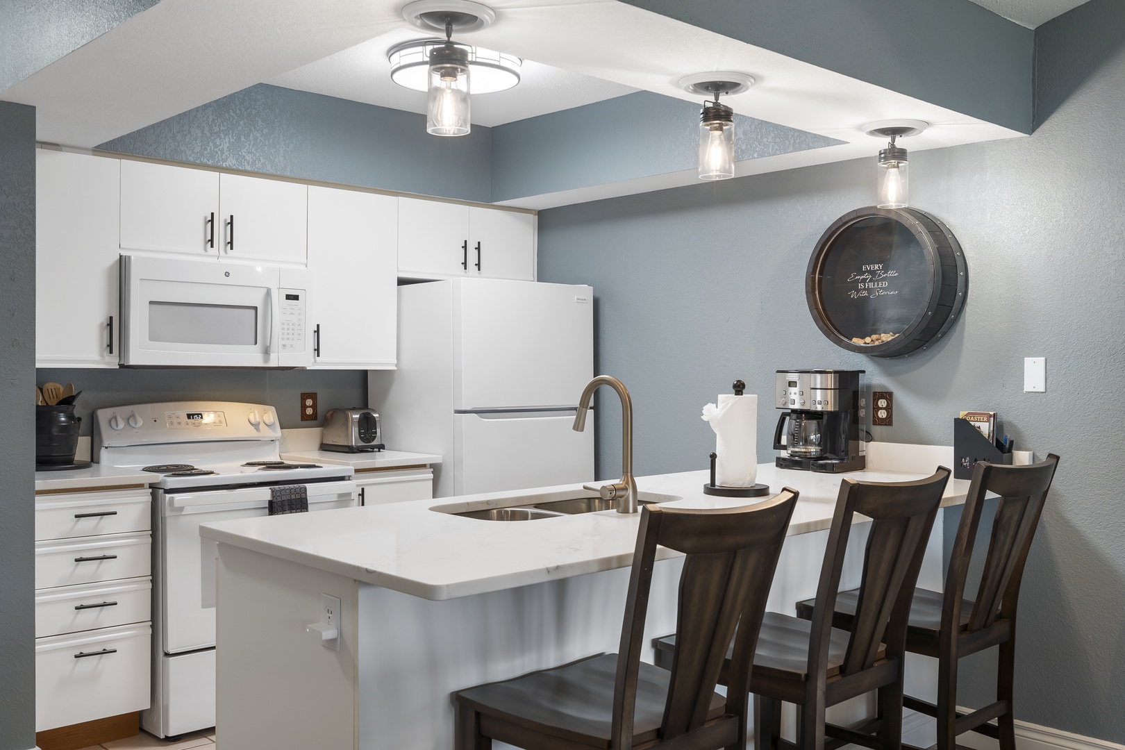 The open, breezy kitchen offers ample space & every home comfort