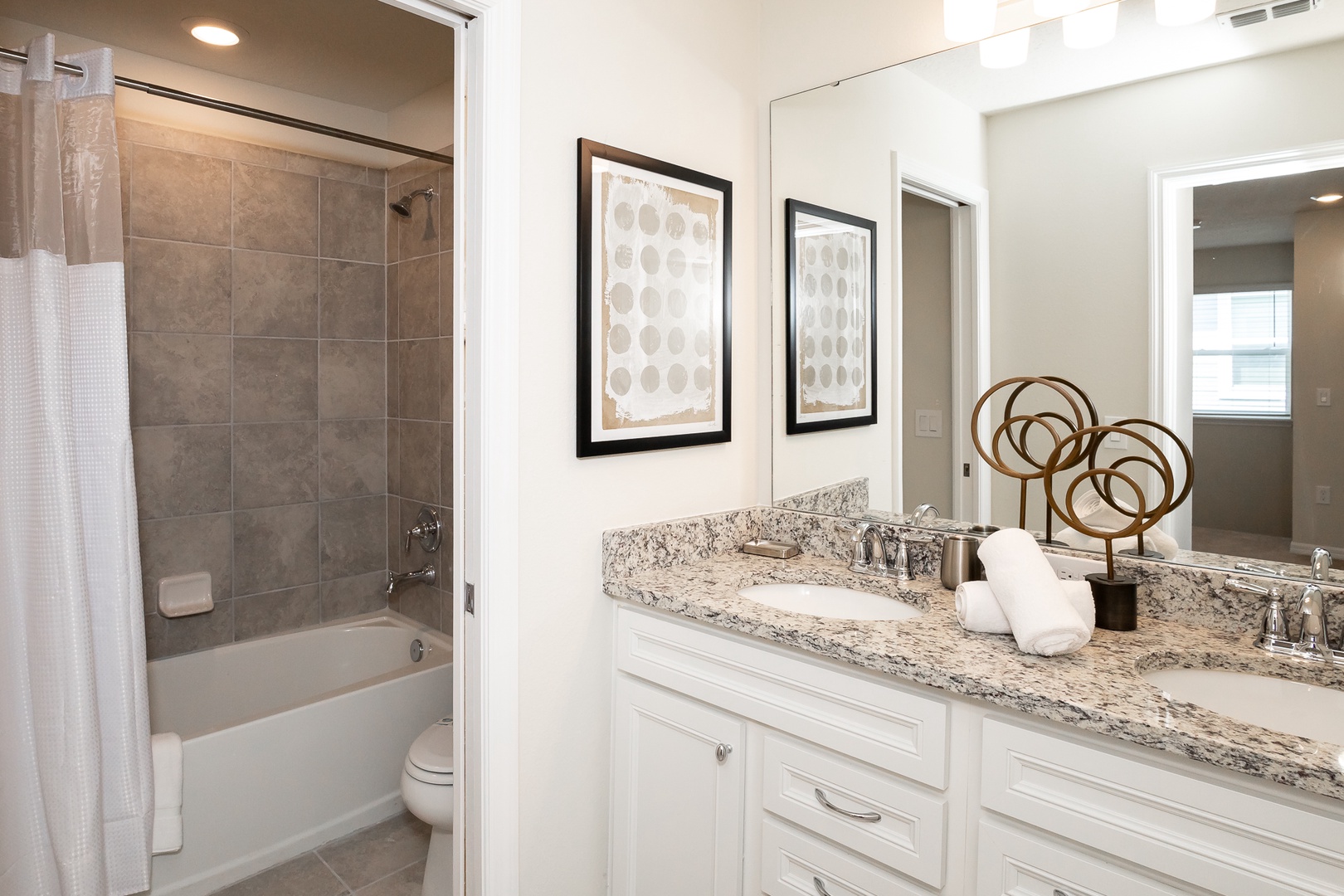 Bathroom 2 on the 2nd floor offers a double vanity & shower/tub combo